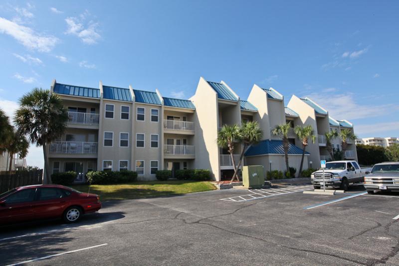 Poolside Villas ... Discover this cozy little complex of only 30 units out near the west end of the Holiday Isle peninsula. Easy pedestrian beach access from this location on the south side of Gulf Shore Drive. This attractive 3rd-floor 2-bedroom / 2-bath condo enjoys a harbor view from the living room balcony and the master bedroom. This condo is on a vacation rentals management program, so your real estate agent will have to learn when there is a turn-around day for a showing.