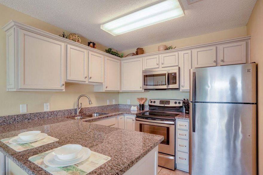 This spacious one-bedroom one-bath ''penthouse-level'' condo is located directly across from the beach. Wonderful views with the security of not being located directly on the beach, you get the best of both worlds. This condo offers something most one-bedroom condos in the area doesn't, it has a set of bunk beds in the hall, an in-unit washer and dryer, a full-size spacious kitchen and a large balcony. Good luck trying to find all that for this price range in Destin! The current owners reconfigured and updated the kitchen to allow more cabinets and space. It features new cabinets, granite counters and stainless-steel appliances. The bathroom was also updated with raised cabinets and granite counters. Tile throughout the condo makes this the perfect place to retreat after a long day at the