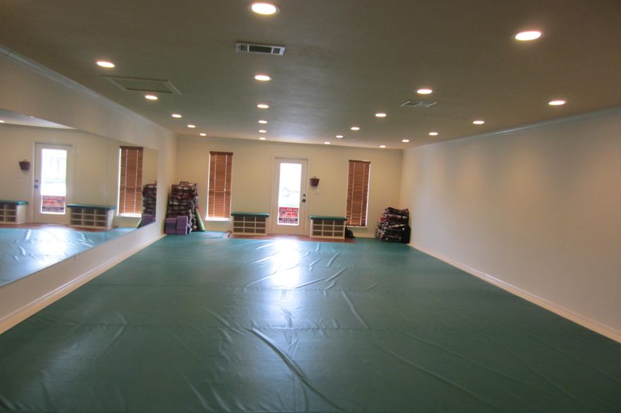 Seller spared no expense completely remodeled space into a Yoga/Fitness studio. Renovations include: new ceiling with recessed lighting .. removal of walls opening up to large studio .. added large mirrors .. fresh paint .. crown molding .. custom cabinetry .. new rear door .. new bathroom .. new hot water heater .. new digital thermostat .. new window blinds .. top of the line custom seamless safety exercise mat. Studio is perfect for any type of exercise/fitness/yoga/marshall arts/gymnastics, etc. Unit is 20' by 40'. Complex is centrally located in the heart of Destin. HOA dues are $215 per mo. which covers water, sewer, trash, ins. & outside maintenance.