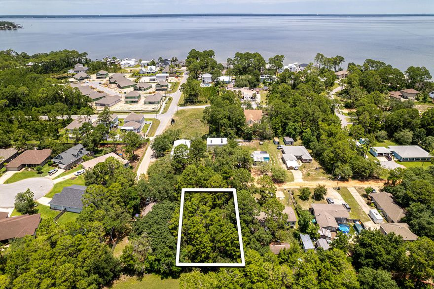 Secluded, vacant, 0.25 acre residential lot in the Mack Bayou area (bay side of SRB).Private and quiet, no traffic! Very close to Grand Blvd! Survey + grant of easement included. No wetlands, no HOA, or restrictions on this piece of property. This means you can maximize usage of the lot with building. Lot can easily fit a main house and additional dwelling unit up to 400 sq. ft. (per Walton County Building Codes) plus pool and outdoor oasis.Seller has plans drawn up and local builder in-place should Buyer want to move forward in that direction or make their own plans with Builder.Currently, lot sits on a private road but Walton County is in the process of taking ownership then road developer will be paving and maintaining the road. Buyer will not incur any cost or special assessment when roads are paved.