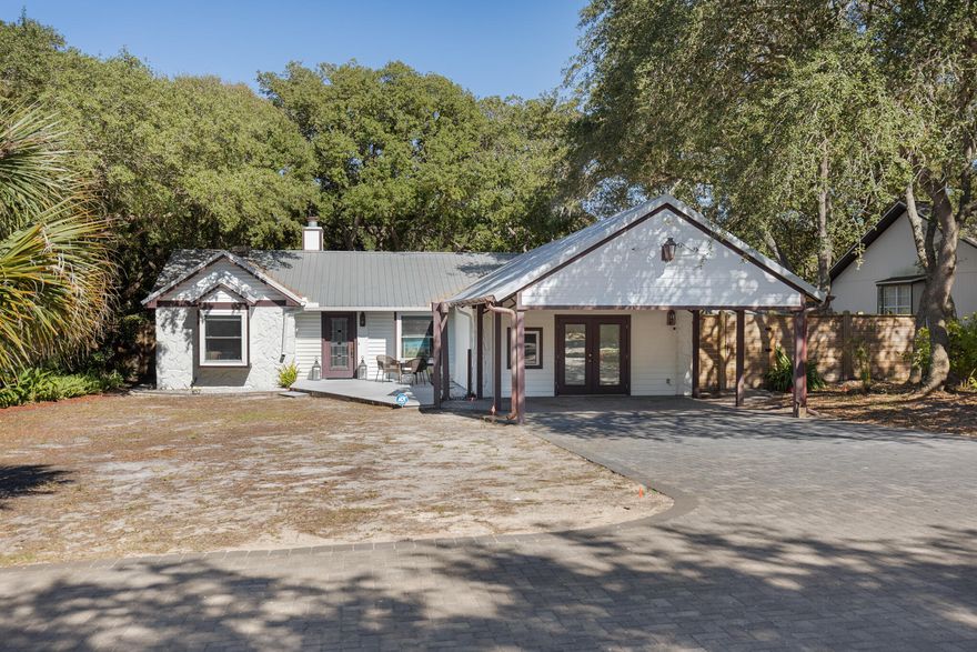 Located on an oversized lot shaded by heritage oaks, this beautifully updated home is just steps from private, deeded beach and lake access -- a quick and easy walk with no major roads to cross. Seller to pay owners title insurance and transfer tax on the deed with acceptable offer.Whether you're looking for a primary residence, a second home, or a high-return investment, this property offers an unbeatable combination of location, features, and potential. Step inside to an open and airy floor plan, enhanced by vaulted ceilings and a wood-burning fireplace. The living area is finished with travertine stone flooring, adding both durability and style. Step inside to an open and airy floor plan, enhanced by vaulted ceilings and a wood-burning fireplace. The living area is finished with travertine stone flooring, adding both durability and style. The remodeled kitchen stands out with custom maple cabinets, quartz countertops, stainless steel appliances  including a double oven and a sleek backsplash. 

The primary suite is a private retreat, featuring a renovated en suite bath with a double vanity, granite countertops, and a walk-in shower. The additional bedrooms are well-sized, and a converted garage adds extra flexibility  perfect for a fourth bedroom, home office, or playroom. Outside, enjoy the best of Florida living with a spacious yard, beautiful mature trees, and plenty of room to relax or entertain. 

The exclusive beach access means you can reach the sand in just minutes, while the nearby coastal dune lake offers additional opportunities for paddleboarding, kayaking, or fishing. With its prime location and deeded private access to the Gulf, this home is a rare find. 

Contact us today for cost-to-own figures and rental projections.
