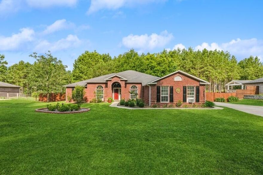 You will be proud to call this home your NEW HOME! This beautiful brick home is located on just over 1 acre of land in the desired Yellow River Plantation Subdivision with access to nature trails, fishing ponds & playground. You're going to feel at home as you enter this spacious open floor plan with lots of natural lighting, high ceilings & beautiful dark hardwood flooring in the foyer, office & dining area. The spacious kitchen has granite countertops, tile backsplash & tile floors. The stainless-steel appliances include stove, microwave, dishwasher (Bosch) & refrigerator (LG). There is plenty of cabinet/storage space along with a spacious pantry. At mealtimes, you can eat at the breakfast bar or in your formal dining room. The kitchen overlooks a large living room area