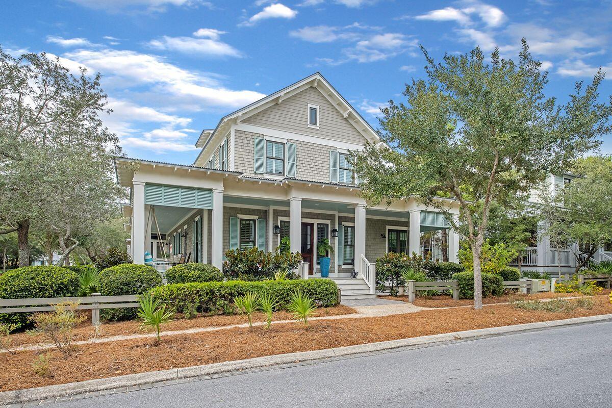 Impeccably maintained and positioned on a large corner lot just steps from Frog Pool, this WaterColor Phase III home is being sold by its original owners who spared no expense in its details. Ideal as a primary residence, vacation home or rental investment, this home offers instant curb appeal with a wraparound front porch and screened back porch, a carport readied for a carriage house (utilities have been pulled and plans will convey with sale) and a fenced backyard perfect for a pool. The open floor plan inside includes a chef-inspired kitchen with double islands, designer cabinetry, breakfast bar with seating for six, and stainless appliances including gas range, two dishwashers and an oversized refrigerator.