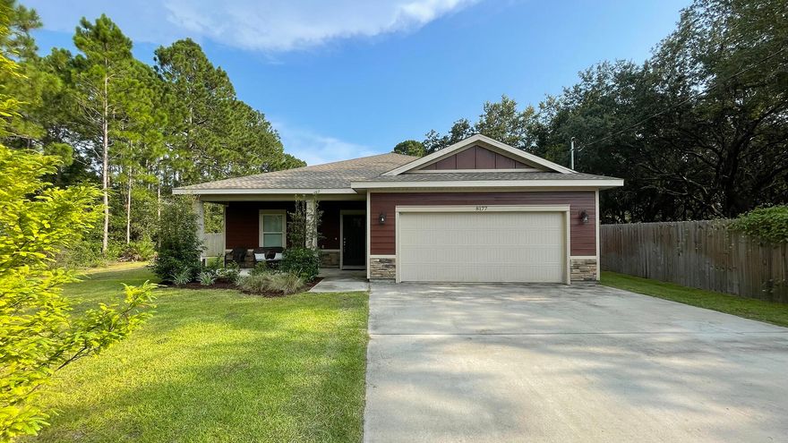 MOVE-IN READY, UPDATED THREE-BEDROOM TWO-BATH WITH LARGE YARDSet off the street, at the end of a long driveway, this beautiful updated three-bedroom, two-bath home is move-in ready. You'll be wow'd by the upgrades like the mixture of hardy plank and stone on the front of the house; columns on the front porch, perfect for rocking chairs; and high ceilings, vinyl plank flooring and crown molding throughout. Transom windows provide a high-end custom touch. A long foyer, with coat closet and dark vinyl plank flooring leads to the open floor plan with living area, kitchen and dining area. Hallways on either side lead to bedrooms of the split floorplan. Off to the right, the tiled laundry room is ready for washer and dryer. The main bedroom suite is tucked away on this side of the house for
