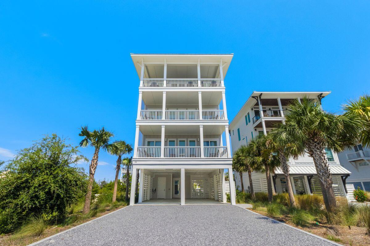 Experience effortless coastal living in this stunning North Cape San Blas residence. This four-story home offers five bedrooms, five-and-a-half bathrooms, and accommodates up to 14 guests, making it perfect for extended family or entertaining friends.The ground level features a tiled entry with beach gear storage, a private heated pool, outdoor shower, and space for lawn games. Two king bedrooms with ensuite baths and a kid-friendly bunk room are located on the second floor, along with porch swings and partial Gulf views.The third level includes a casual lounge with an arcade game, corner sofa, and TV, as well as the primary suite and an additional king bedroom, both with private baths and access to furnished decks. A dual washer and dryer setup adds convenience for larger groups.
The top floor boasts vaulted ceilings and multi-toned wood floors in the open living and dining areas, framed by striking Gulf views. A gourmet kitchen with high-end appliances, an eight-seat breakfast bar, and a twelve-seat dining table is ideal for entertaining. Additional features include a wet bar, expansive deck with alfresco dining, and a Gulf-facing balcony perfect for sunsets.
Entertainment and comfort continue outdoors with multiple lounge areas, a ping-pong table, fire pit, outdoor TV, and abundant seating. Additional amenities include an EV charging station and easy access to the beach just across the street. This property offers a rare opportunity to own a Gulf-view home that combines luxury, practicality, and the best of coastal living.