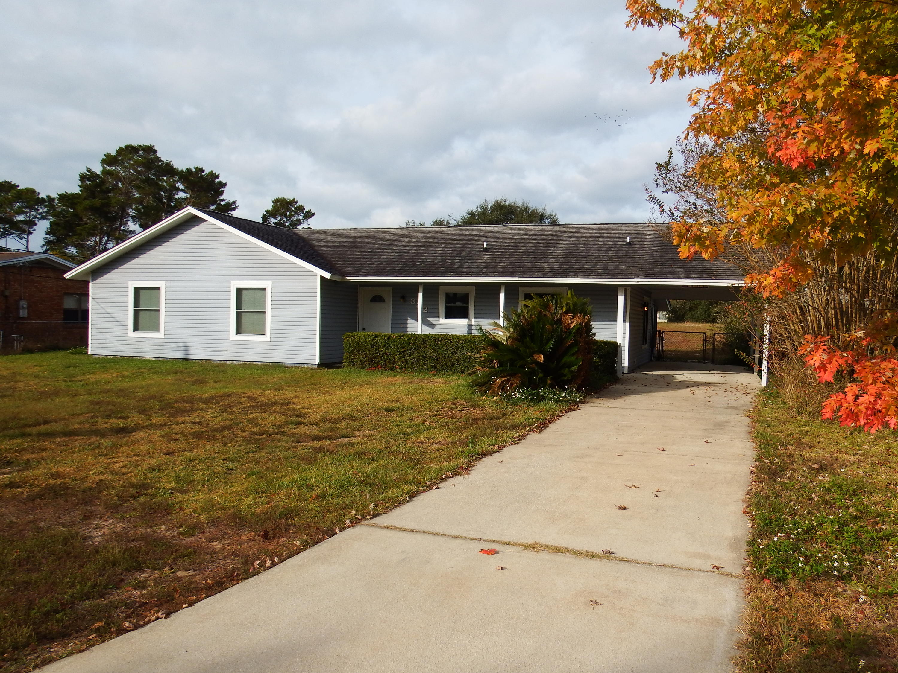 Located just minutes to Hurlburt Field, & a few miles from shopping, restaurants, & beaches: This 3 BR, 2 BA home, would make a great starter home/investment property! The interior has been freshly painted, ALL appliances convey, & the large backyard boasts plenty of room for a pool! The kitchen has a breakfast bar that opens up into the 29x12 living room, which features a wood-burning fireplace, & due to the size, can be divided off to create an office space, crafting area, etc. The guest bath features a skylight & has a newly added cultured marble tub/shower combo with upgraded faucets (2012). The screened porch area has also been newly painted, re-screened, & has had new doors installed (2014). The roof has been replaced & the carport upgraded to wood from aluminum (2004). Vinyl siding,