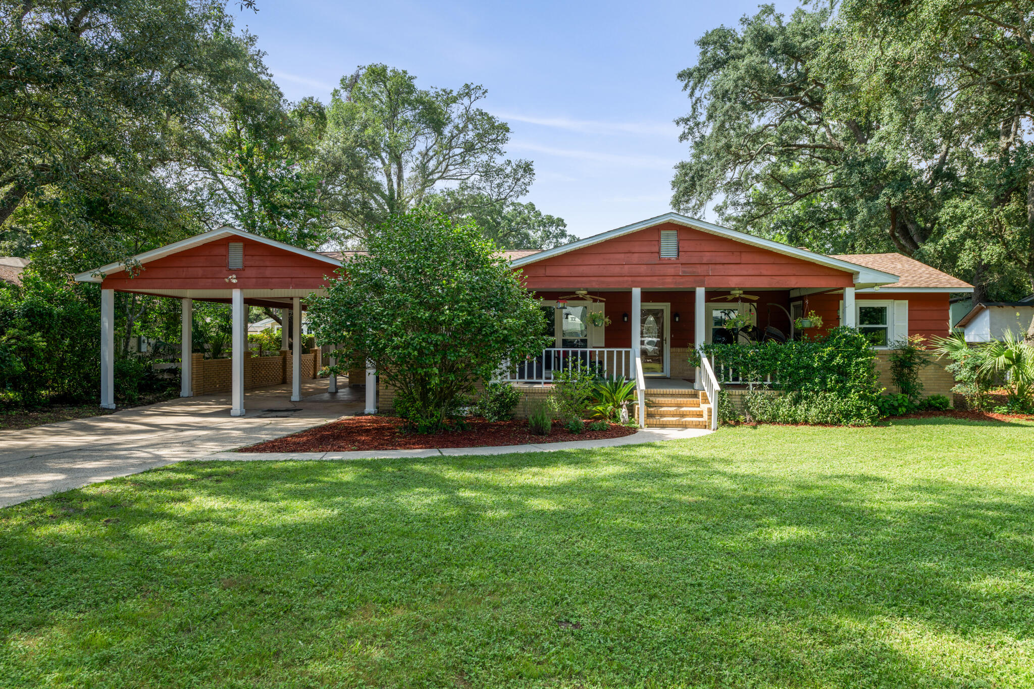 Welcome to this 4 bedroom, 3 bathroom gem nestled in the heart of Gulf Breeze Proper - centrally located on Fairpoint Dr - just minutes from shopping, dining, sports, local schools, and Pensacola Beach! This unique property offers a perfect blend of modern updates and classic charm. Starting with the CUTEST covered front porch to sit outside and relax with your morning cup of coffee, and the covered carport with extended concrete pad for ample parking for friends, family, or to store your boat behind the gate. This home also features all new windows, refinished hardwood floors, and a fully remodeled and BEAUTIFUL kitchen with large kitchen island with breakfast bar, quartz countertops, stainless steel appliances, and an undermount tub sink - perfectly framed in the bay window for the best view of the backyard. Just off the kitchen is the dining room that has a door leading to the open deck in the expansive backyard. Down the hall are all of the bedrooms, each with Jack & Jill bathrooms - giving access to an ensuite from every room. The front bedroom even has its own entrance from the front of the house - great for a lockout or mother-in-law suite. Schedule your showing today and check it out for yourself!