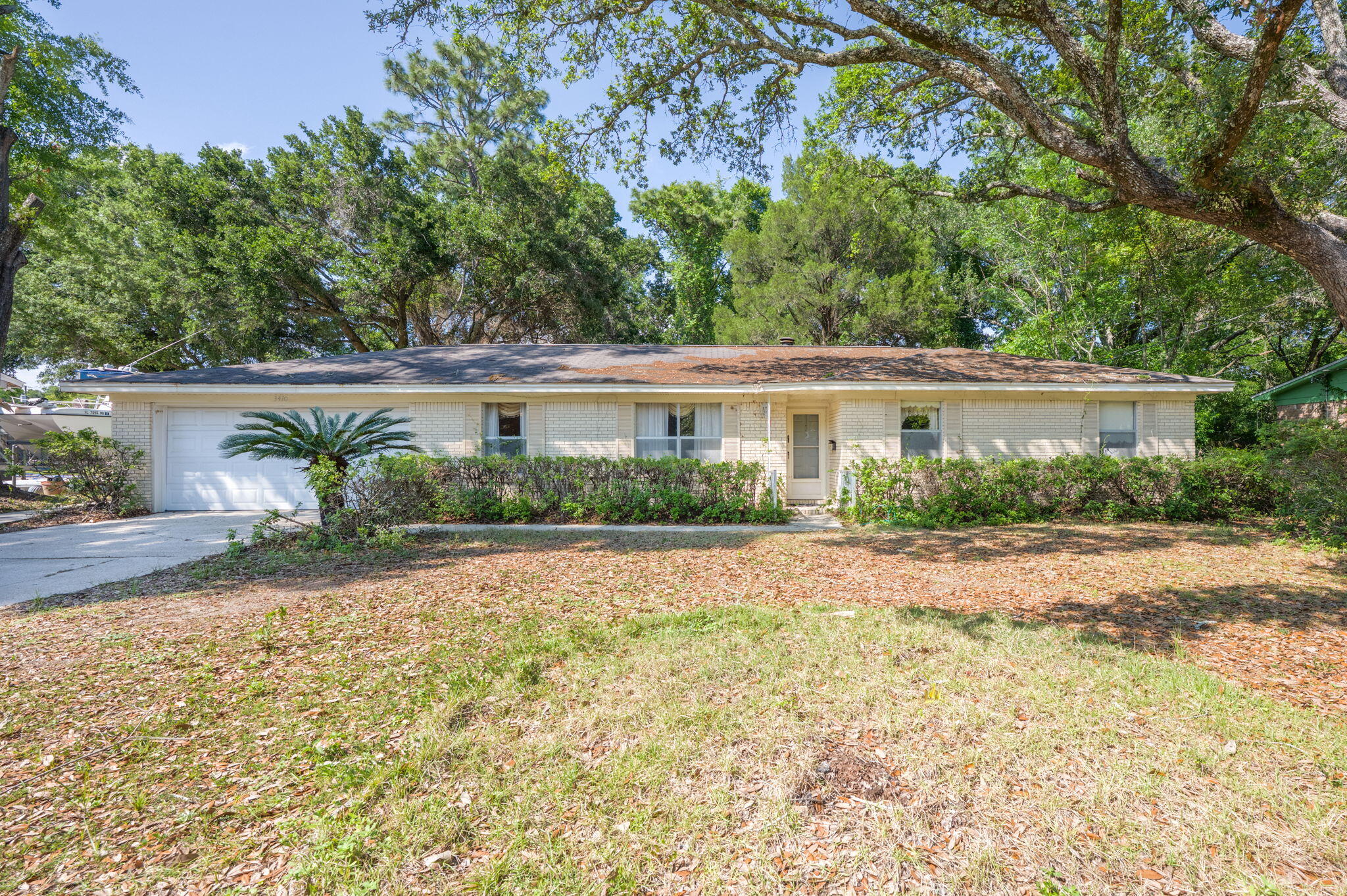 If you've been searching for a home with potential in an unbeatable location, this is the one! Nestled just off Scenic Highway, this charming 3-bedroom, 2-bathroom property is central to everything Pensacola has to offer -- minutes from the airport, shopping, dining, interstate access, a community center, and more. The lot boasts mature trees, providing both privacy and shade. Inside, you'll find a thoughtfully designed layout with a spacious front family room and a cozy living room featuring a beautifully detailed stone fireplace -- the perfect centerpiece for relaxing evenings. The wood-paneled walls throughout the home create a warm, inviting atmosphere, full of character and originality. The true primary suite includes its own private ensuite bathroom. A standout feature is the large s unroom, ideal for enjoying the peaceful view of the shaded backyard year-round. The home also includes an indoor laundry area, multiple linen closets throughout the home offering extra storage, and a 2-car garage. This home offers the perfect canvas for someone with vision to create their dream space. Whether you're looking to customize, update, or simply add your personal touch, the possibilities are endless. Don't miss your chance to own a home in this highly desirable location. Come see the potential for yourself!