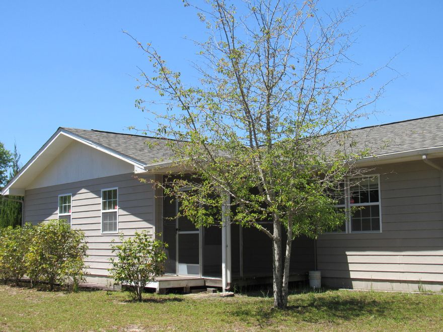 Peace, tranquility and the perfect location! This move-in ready home is situated on 5 acres and is close to town. The paved driveway is lined with cedar trees and azaleas. Upon entering the 3/2 home you will notice an over sized living room and family room. Attention to detail is noted in the built-in bookcases and shelves. The open kitchen/dining features an island with extra storage and the kitchen cabinets have slide out shelves. Utility room features brand new front loading washer and dryer that stay! The 2 car garage is complete with extra storage cabinets. Two screened- in porches. Numerous outbuildings including a 30x30 barn and 20x20 shed. Riding troy-built mower will convey! The roof was replaced in 2014 and this home is in great condition. A current survey is on file. Call today!