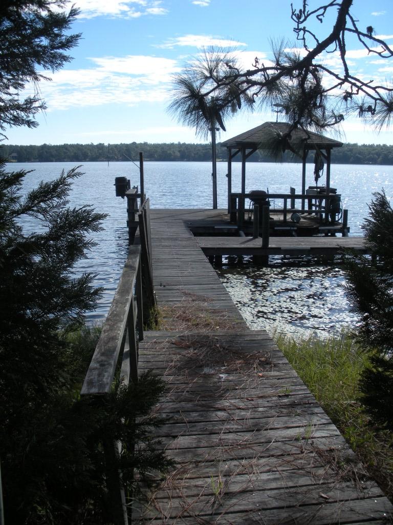 Modern lakefront home with brand new HVAC system on about 2.61 acres awaits you! This all-brick 3 bedroom, 2 bath home with split bedroom plan sprawls on tranquil Spring Lake with 225 ft on the lake itself! This is more access to the lake than most of the 1 acre lots! Your side entry garage, oversized 2 car garage, and extended driveway gives the home great curb appeal and will allow many guests to visit you! The peace and quiet hear will disarm you! The awesome wide tiled entry offers pillars and a lovely access to the great room with 12 ft ceilings, wood burning fireplace, and decorative shelving. The office could easily be converted to a 4th bedroom, if you feel the need, or keep it as an office / reading room. Call for your appointment today! For more information, click ''More''