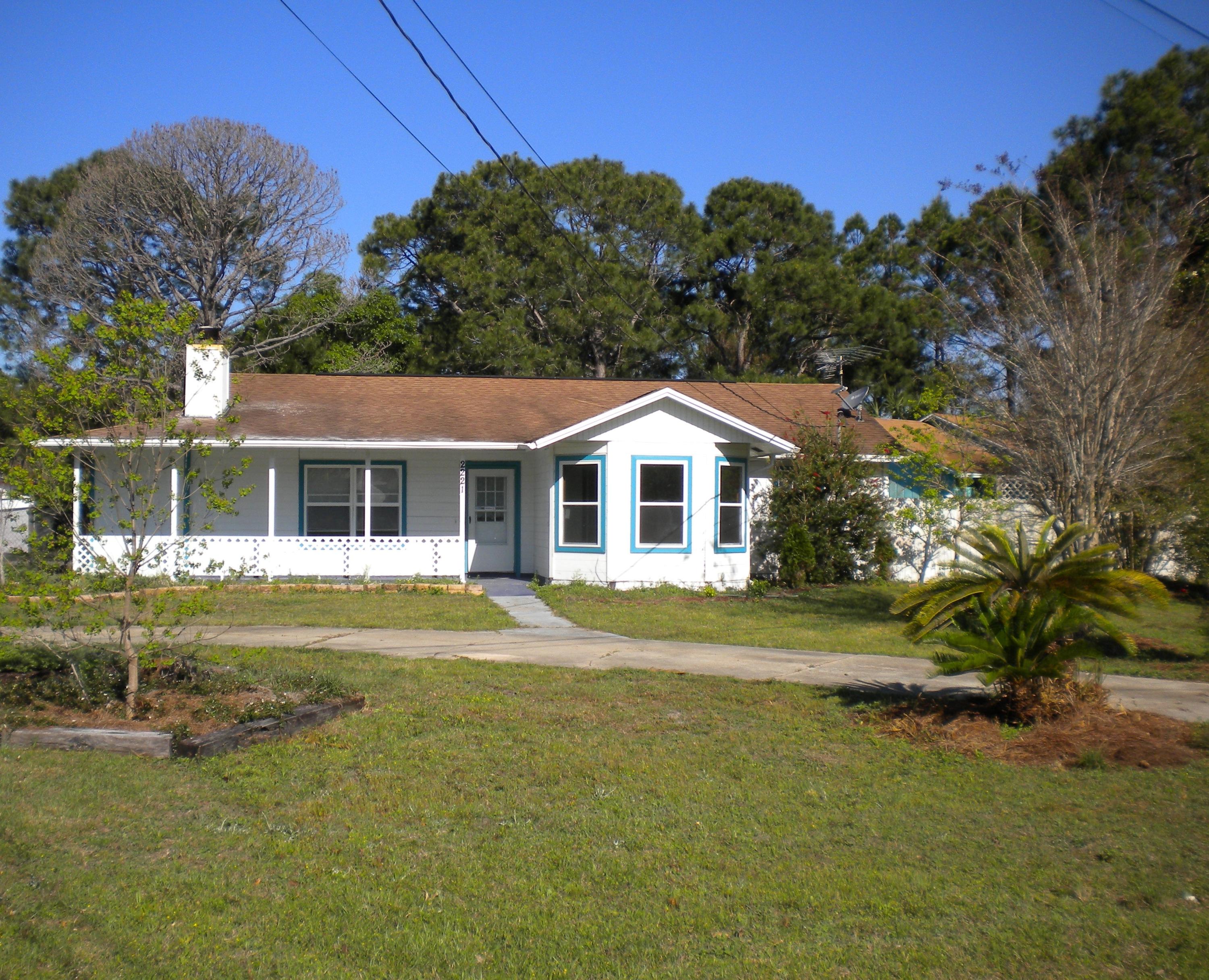 CHARMING COTTAGE HOME! Covered Porch and CIRCLE DRIVEWAY on a 1/2 acre CORNER LOT, large fenced yard easy access for boat, jet ski or RV storage. CONVENIENTLY located to the BEACH, SHOPPING, HWY 98 & 87. Brand NEW WINDOWS! Living room offers added warmth with stone accents with raised hearth woodburning FIREPLACE, NEW KITCHEN CABINETS, stainless steel smooth surface stove & built in microwave. Dining area has Cedar SHIPLAP Wall that accents Bay Window. Large Laundry Room with convenient access to backyard. Second Bedroom features SHIPLAP wall accenting bay window. Storage building/workshop and Shed are to convey ''as-is''. Square footage to be verified by buyer