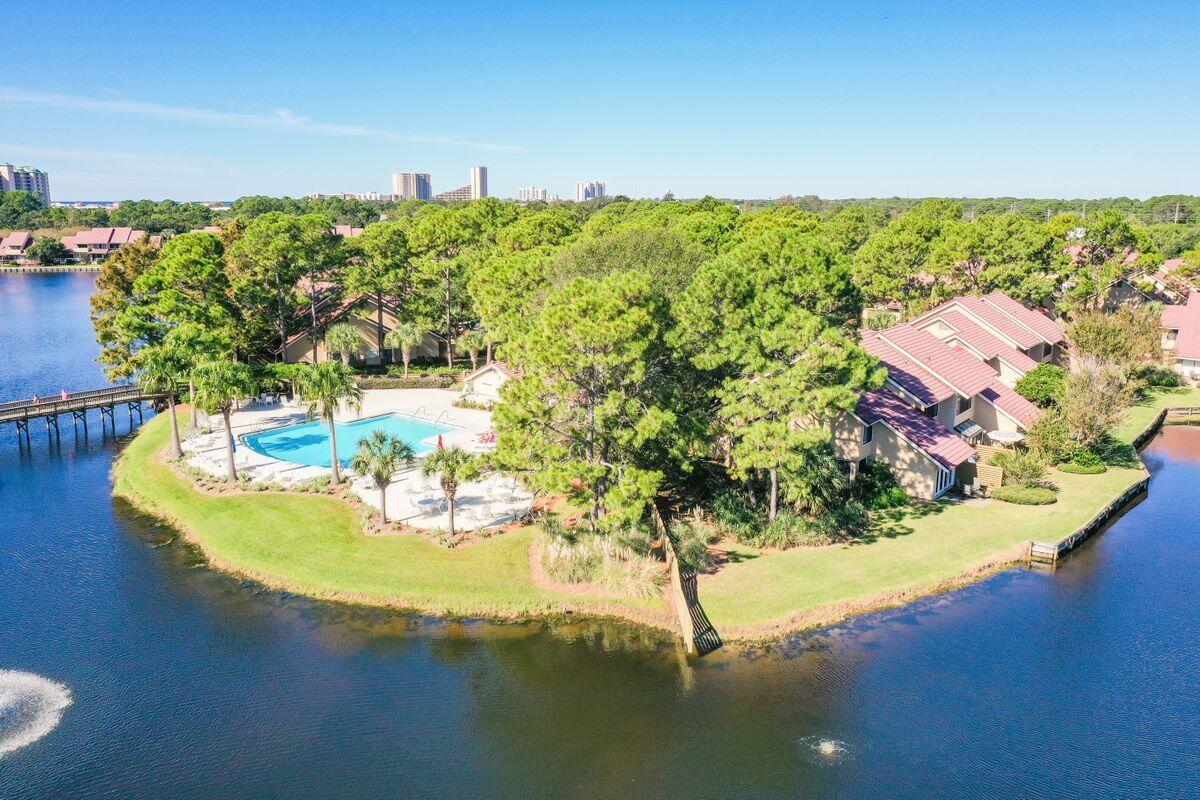 Resort living is within reach in this three-bed, end-unit townhome with loft on the beachside of gated Sandestin Golf & Beach Resort. Nicely decorated with custom finishes and tasteful furnishings, this two-story villa offers a ground-floor owner's suite and open patio that boasts views of Horseshoe Lake and lush landscaping next to the Beachwalk community pool. Inside the townhome, an updated kitchen opens to a light and airy dining space and the living room, perfect for intimate family gatherings. This property yields excellent rental potential with $50,000+ in gross annual rental projections.