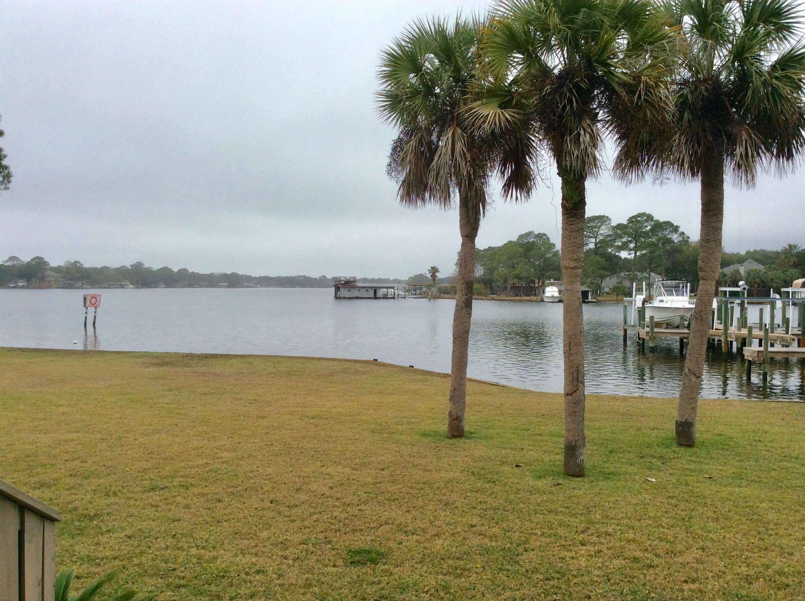RARELY do these come on the market for sale. WATERFRONT townhouse with BOAT SLIP. This small waterfront townhouse community is centrally located in town. Tile throughout downstairs, granite counters, tall kitchen cabinets, breakfast bar. and wine rack. Waterviews of the bayou from the kitchen, dining, living area and sunroom. Large deck off the back with room to entertain, BBQ, enjoy morning coffees and evening relaxation. Bedrooms upstairs are all generous in size with added bonus of full balcony upstairs. Additional storage is located behind door of 3rd bedroom. Half bath downstairs also has closet storage. Laundry located off sunroom. Enjoy Florida waterfront living in this delightful townhouse.