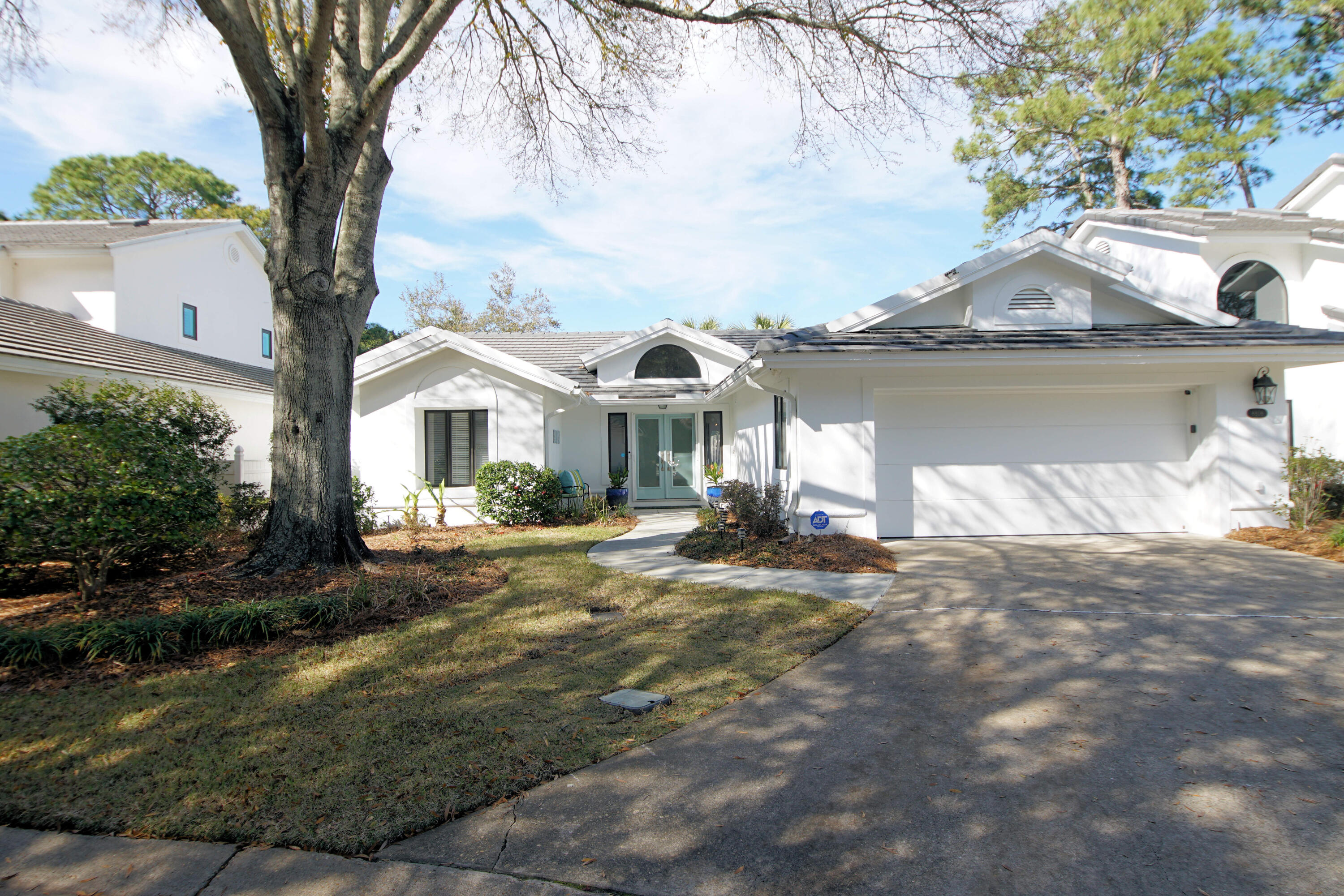 This beautiful home on a cul-de-sac   located in the rental-restricted neighborhood of St. Andrews offers unobstructed views of the ninth fairway of Baytowne Golf Course, one of its many lakes and a quaint foot bridge. This single-level home has 3 bedrooms and 2 baths and many upgrades including new kitchen appliances, quartz countertops, and upgraded cabinets. New exterior paint, new landscaping, installed 50 amp, 220V circuit for EV charging station in the garage, ADT Security system, and a new roof installed in June 2022. See documents for more details.The double front doors make moving large furniture a breeze. Once inside you will notice vaulted ceilings, hardwood flooring, archways, and built-in cabinetry.
