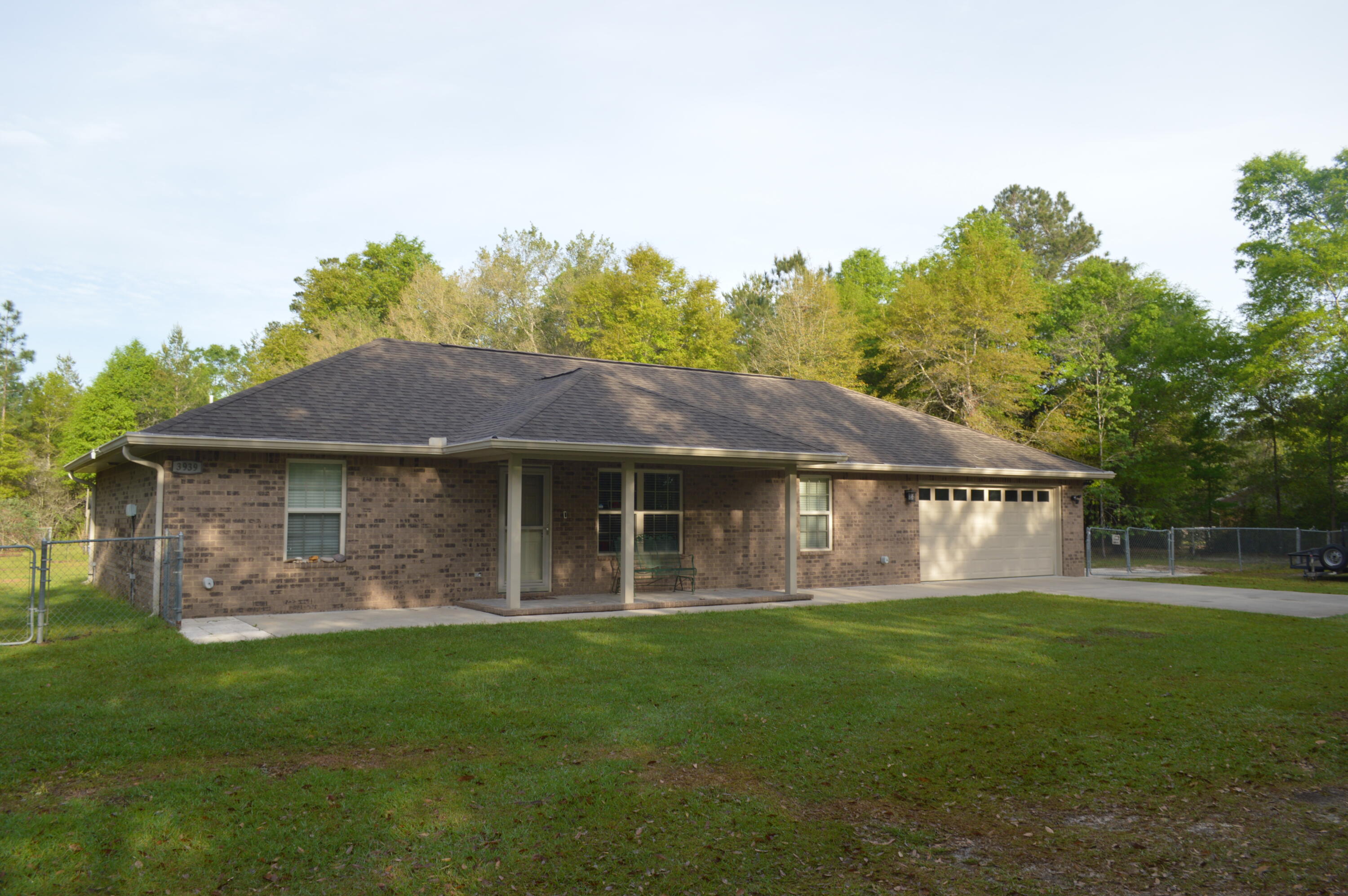 Just shy of 5 acres....No HOA....private drive and homesite...home built in 2013 by one of the area's best and most conscientious builders....county zoning for lower taxes and animals allowed...if this doesn't check all of your boxes, you're too needy!  All brick 3 bedroom and 2 bath home...split floorplan...galley kitchen with tons of cabinets and plenty of counter space....tile in the wet areas and carpet in the bedrooms...utility room with extra refrigerator and freezer...extra deep garage...beautiful lot with persimmon trees, Asian pear, blueberry bushes, peach tree and blackberry bushes...gutters...well and sprinkler system...natural woods affording plenty of privacy...outdoor storage sheds and a metal workshop...don't miss this one close to town but with a private country feel!