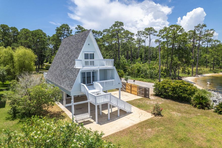 SELLING 2 PARCELS TOGETHER 29-2S-28-0000-01002-0000 & 20-2S-28-0000-00500-0000. Projected rental income of over $50,000 annually! This one-of-a-kind A-frame waterfront retreat offers an incredible opportunity for homeowners, investors, or those seeking a versatile vacation home. With $20K+ in rental projections for the private studio on the first floor with its own separate entrance (506 sq ft). An additional $33K projected for the main house (2nd & 3rd Floor...1008 sq ft). Nestled at the end of a dead-end street, this 3-story home sits on a spacious 0.8-acre corner lot along the tranquil shores of East Bay. Its unique architecture, fresh interior and exterior paint, new roof and combined with stunning water views and a private (NEW) dock, creates a serene coastal escape like no other! T he ground level features a studio with a private entranceperfect for rental income, guests, or multigenerational living. The studio offers water views, a kitchenette, a full bathroom with a large vanity and walk-in shower, and direct access to a large covered patio overlooking the bay. Upstairs on the second floor, the main living area features a kitchen with stainless steel appliances, butcher block countertops, and a stylish white tile backsplash. The living room is filled with natural light thanks to expansive sliding glass doors that frame the water and lead to a covered balconyideal for outdoor dining or simply enjoying the view! This level also includes a bedroom and full bathroom. The third floor is home to the primary bedroom suite, which boasts water views galore and private balcony access through large sliding glass doors. A second bedroom sits at the opposite end of the floor, with a full bathroom located between them. Enjoy outdoor living at its finest with multiple decks and balconies, a private dock for fishing or kayaking, and a generous yardperfect for gardening, kids, or pets. Located just off Highway 98 and minutes from Pensacola Beach!