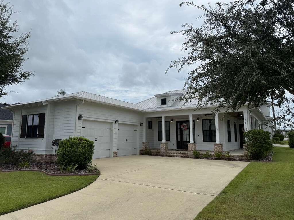 Full of charm and character, this Craftsman-style home is located in Niceville's premier community, Deer Moss Creek. This one-story residence features three bedrooms, two full baths, and a desirable open-concept floor plan designed for modern living. A welcoming wraparound front porch greets you and your guests before entering the bright and airy living room and kitchen, highlighted by 10-foot ceilings, tall dormer windows, and beautiful wood-look tile flooring throughout.The kitchen is a true showpiece, offering white quartz countertops, white shaker-style soft-close cabinetry, stainless steel appliances, a gas range, a farmhouse sink, open built-in shelving, and a spacious walk-in pantry, perfect for keeping everything organized. Just off the kitchen, a convenient laundry room provides additional storage and functionality.
The private primary suite features a generous walk-in closet and a spa-inspired bathroom with double vanities, a tiled glass shower, and a relaxing soaking tub. Two additional bedrooms are thoughtfully designed to provide comfort and versatility, ideal for guests, a home office, or a family. The guest bathroom features a stylish walk-in glass shower, modern fixtures, and elegant finishes, creating a welcoming space for visitors.
An oversized two-car garage offers plenty of room for parking and storage. Outside, the wraparound porch and beautifully landscaped surroundings encourage outdoor living and connection with nature.
Perfectly located just minutes from Eglin AFB, Destin-Fort Walton Beach Airport (VPS), Northwest Florida State College, Twin Cities Hospital, and the white-sand beaches of Destin, this home combines comfort, convenience, and lifestyle. Deer Moss Creek?? is thoughtfully planned around its natural surroundings, featuring parks, bike paths, wide sidewalks, and beautifully designed streets that invite residents to enjoy the outdoors.
Pets may be considered on a case-by-case basis with owner approval and a non-refundable pet fee. Smoking and vaping are not permitted inside the home.