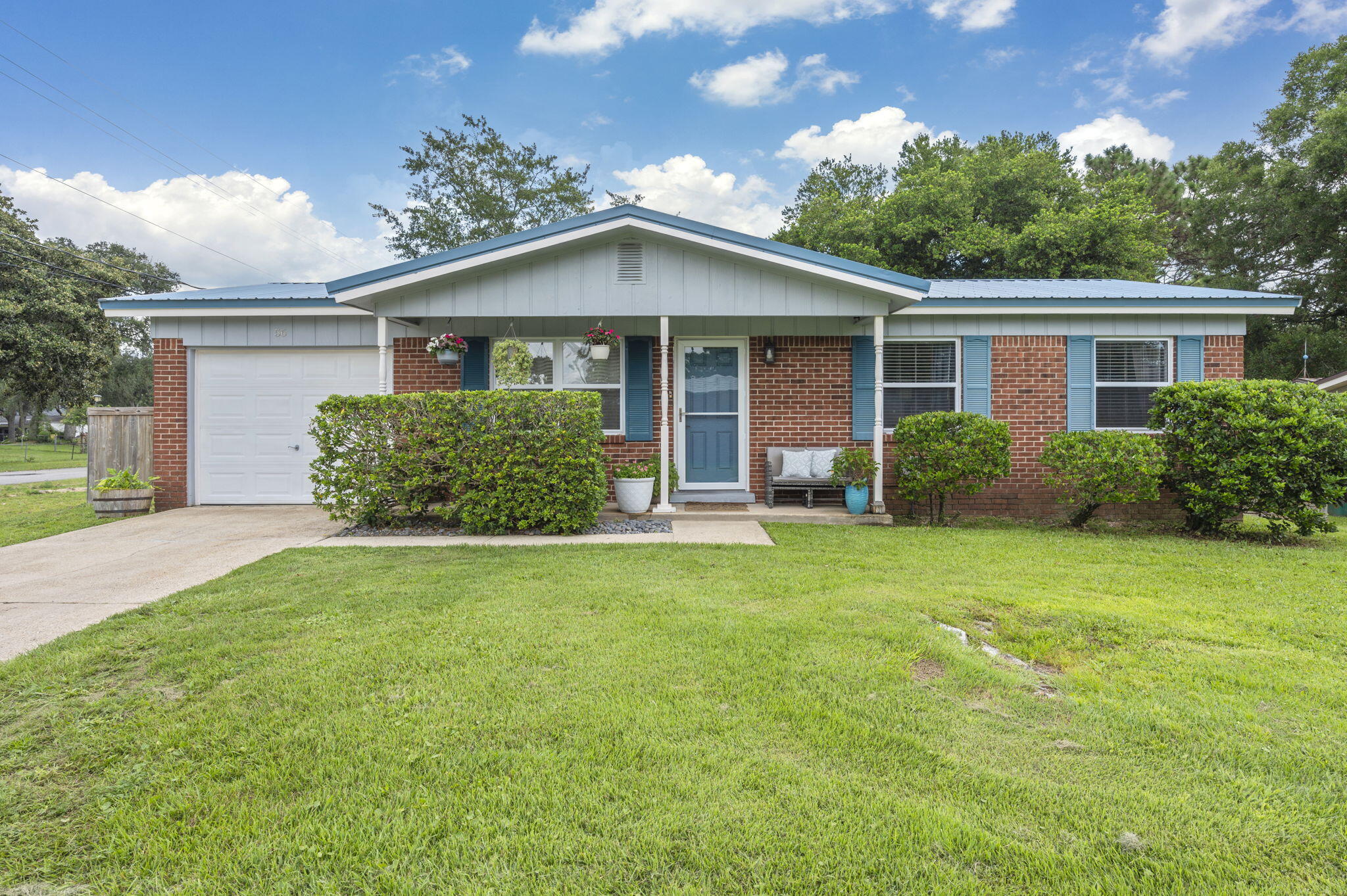 Adorable brick home with a fresh coastal vibe! This updated 3 bed, 1.5 bath beauty boasts a stylish kitchen with painted cabinets, luxury vinyl plank flooring, and a bright open layout. Relax in the spacious living room or entertain in the large fenced backyard with patio. The home features a newer metal roof for peace of mind, modern lighting, and a one-car garage with laundry area. All this on a corner lot--close to schools, parks, and much more!