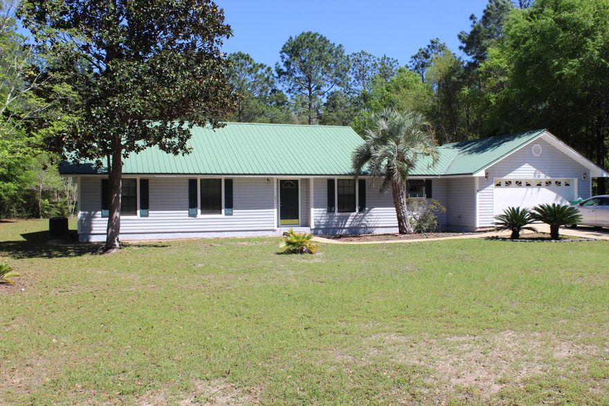 Immaculate, low maintenance home with RV parking that can fit a large motor coach located on an acre. Metal roof, tile,vinyl flooring, spanish lace textured walls, wood burning fireplace, large spacious kitchen with solid wood cabinets, and screened patio. Country Living but yet located close to schools,library, shopping, and restaurants. Enjoy fishing or picnics near the lakes. Owner to provide an Old Republic Home Warranty.