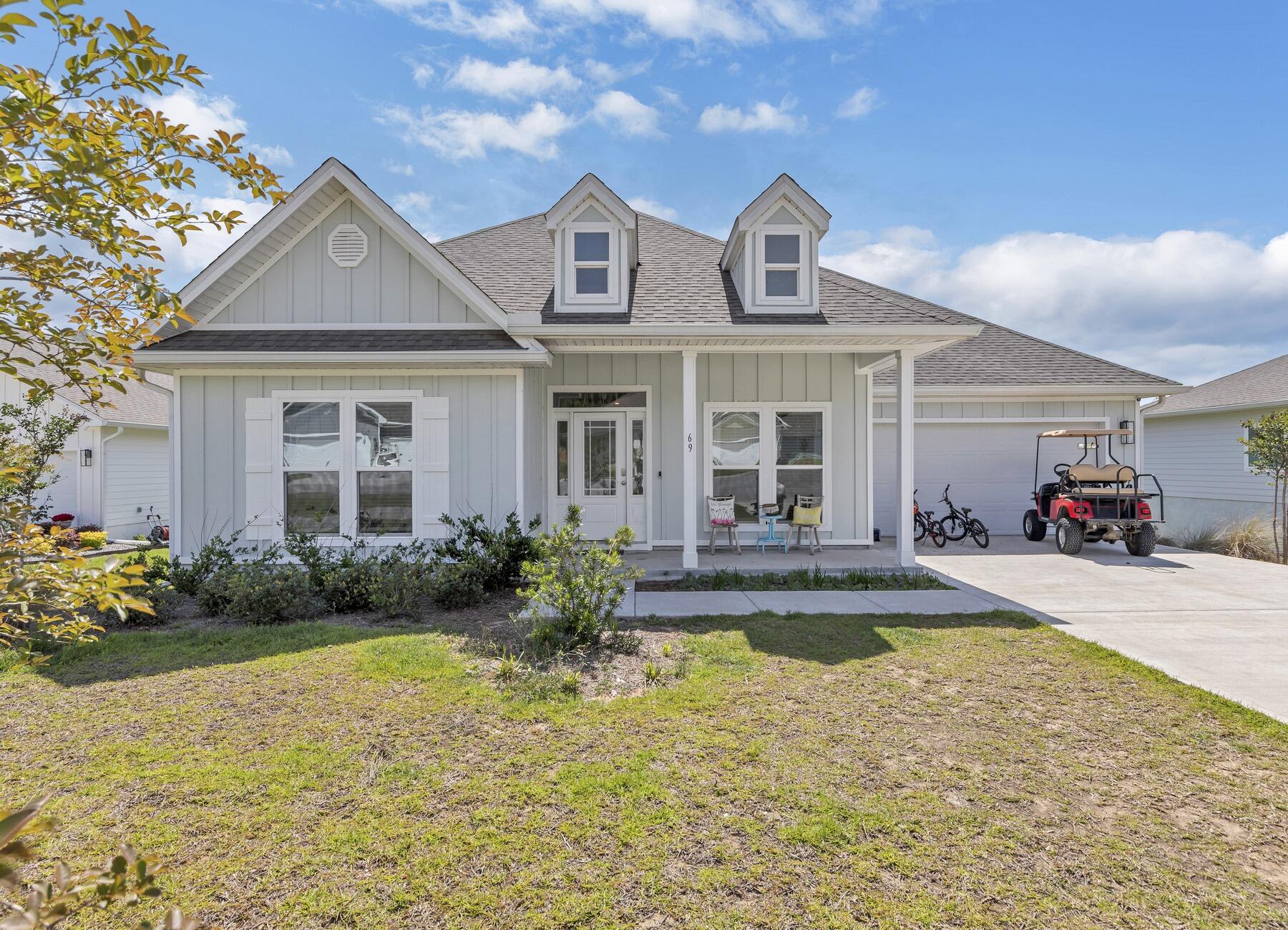This sprawling 5-bedroom 3-bathroom home in Hammock Oaks Estates is sure to please! Inside the front door, you'll find a modern layout with high ceilings, crown molding, luxury vinyl plank flooring and lots of natural light. The kitchen is open to the living room at the back of the home and features granite countertops, an under-mount sink and a huge center island with seating for a crowd. Just steps away, you can grill up dinner this summer on the lanai overlooking the pond in the backyard. The property is lined by towering trees, and that land behind the house is protected.Back inside, the isolated primary bedroom has access to the lanai and includes tray ceilings. This ensuite boasts a large walk-in closet, dual sinks and a custom tile shower. On the other side of the house,