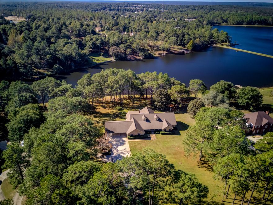 Prestigious TEW BUILT home in the popular Ridgelake area. 2.64 acres on the 15+ acre Ridge Lake. Panoramic views from the home, Porches and Carport. This well built home is waiting for its new owner to give it their updates! There is so much potential with the extra large rooms...especially the Kitchen with an abundance of cabinets and counter space. The Living Room opens to the Florida Room, which overlooks the Lake and opens to the porch. Formal Dining, Eat-in Kitchen, and Breakfast Bar all make this home great for entertaining. The Garage is access from the Carport and has a Workshop area, plus a separate Office that is heated and cooled. The Basement (not included in the SF) is ideal for extra storage. Added extras: a deep well, Gazebo and private Dock....fish from your back yard!!