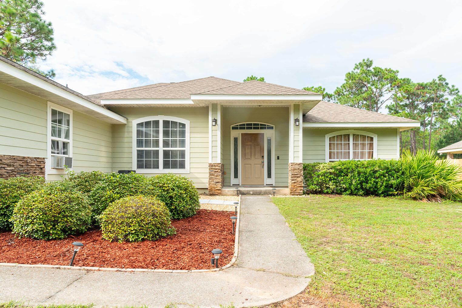 Lovely home in Navarre on a 1/2 acre lot!   4 bedrooms, 2 bathrooms and a 2 car over-sized  garage.  HVAC replaced in 2021. new roof and new water heater in 2024. New privacy fence. in back yard. Kitchen has 10 foot ceilings,  granite counters, fridge and dishwasher are two years old,  maple cabinets and a breakfast bar.  Living room has beautiful hard wood flooring and 10 foot ceilings. The master bedroom and living room open to a covered lanai looking out over the fenced back yard.  Home wired for ADT and can be activated. (Not active now)  Yard building and lawn pump and sprinkler system on well.