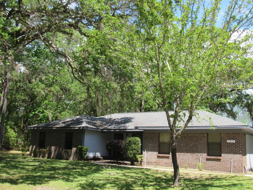 Room to Roam on this beautiful 2.23 acres! Home has been updated with new duct work, paint, flooring and window blinds. This home is located on four beautiful lots with large canopy oaks in Freeport. Bring the family and build 3 more homes! The existing mature home has been well kept. The home features a sunken living room, wood burning stone fireplace and screened in porch! The garage has been converted to a storage/workshop and utility room. This property backs up to Hammock Bay and is within a mile to a public boat ramp and the Regional Sports Complex! The bike path runs in front of this home and it is in a highly desirable location. The home is currently connected to public water and sewer, the well can be used for irrigation to save on your water bill. Seller firm. Call for your tou