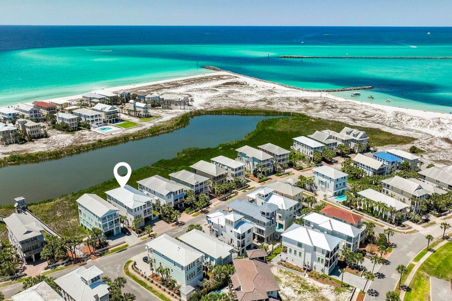 Exceptional views and attention to detail define this coastal modern retreat. Overlooking coastal the coastal dune lake, Lake Christina, this home affords extraordinary views of the lake, Destin's East Pass and the Gulf of Mexico. It's well appointed and has been meticulously thought out from design to conception with its two gulf side master suites, two guest suites and additional bunkrooom with four berths which make this home an ideal retreat for large families. In total there are five and a half baths; giving each bedroom including the bunks, their own bath. Interior finishes are impressive with notable features such as tongue & groove ship lap siding, vaulted beamed ceilings, private elevator; along with wood and tile floors throughout. The first floor.....