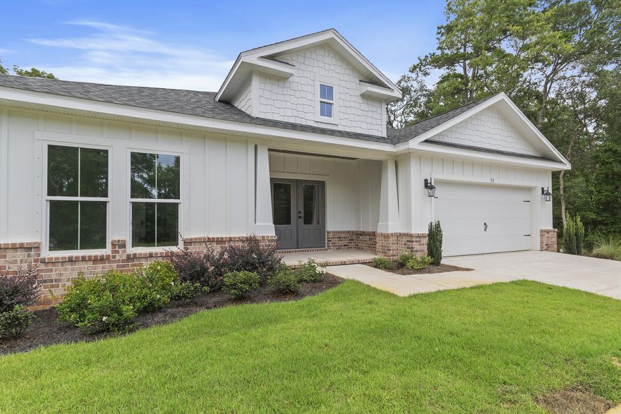 Welcome to your new construction home in the prestigious, gated resort-style community of Bear Creek! This upscale home features, LVP  flooring, Stainless kitchen hood, an electric fireplace, and sophisticated white cabinetry with glass stacks to the ceiling and tile backsplash .The chef's kitchen is equipped with a farmhouse sink and pristine white quartz countertops with a stunning waterfall edge. Nestled on a prime lot, this home backs up to a serene green space with a picturesque creek and mature hardwoods. Bear Creek residents enjoy amenities like pickleball, tennis, basketball courts, a fitness center, and a resort-style pool. Phase 3 will add a second pool and four more pickleball courts. Bear Creek is minutes from the Beaches of South Walton, the bay, fishing piers, parks/dinning