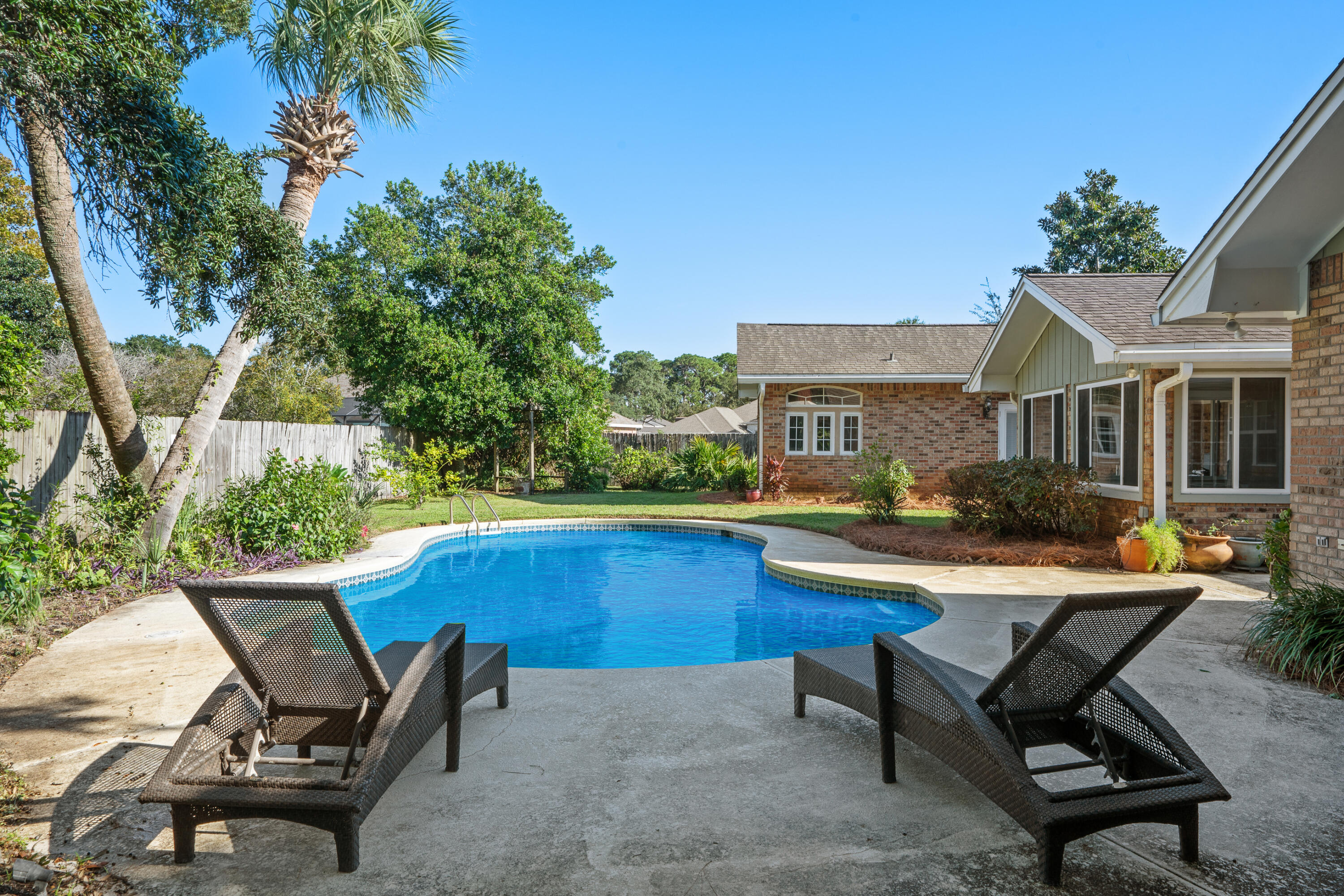 Now is your opportunity to own a beautiful home in the highly sought-after Indian Bayou neighborhood, located in the heart of Destin! This property features a private pool, oversized garage &,an abundanance of living space, making it the perfect retreat. With 4 bedrooms and an extra media/bonus room, you'll have plenty of options for private living space or entertaining. The home has numerous upgrades, including a built-in office area, a large formal dining room/sitting room, and a sunroom. The open concept kitchen is a chef's dream-plumbed for a gas stove, stone counters, and plenty of space to host large gatherings, opening up to the living room which features a fireplace. The spacious fenced-in backyard, surrounded by lush tropical landscaping, ensures privacy and tranquility. The garage is large enough to accommodate two cars and additional storage for your golf cart, tools, or hobbies.  Indian Bayou neighborhood is nestled up to the local favorite Indian Bayou Golf and Country Club. Indian Bayou Golf Club is an 18-hole, premier course designed by golf course architect Earl Stone, established in 1978. So, as you can see, this home is not only perfect in design but also in location!  Schedule your showing today, but be prepared  to fall in love with this home! 