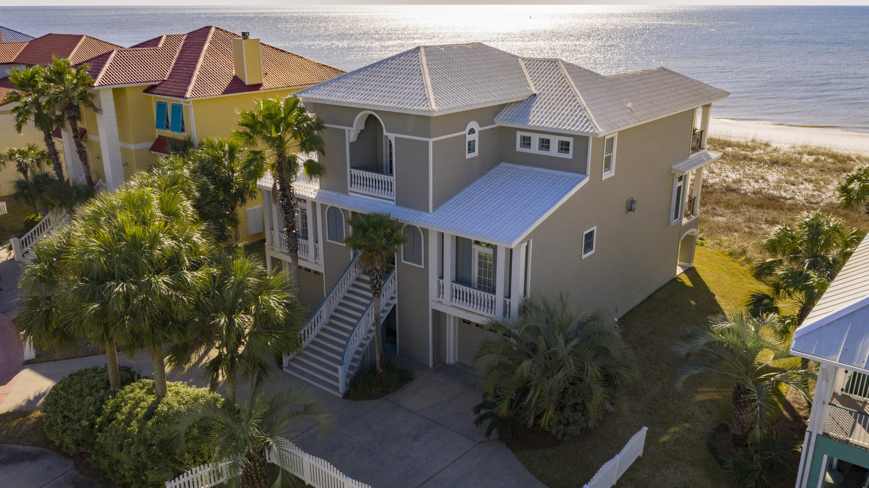 Rare opportunity for beachfront living. 5 BR, 5.5 BA home in gated, private, short term RENT-RESTRICTED Parasol, offering 900'+ beachfront. Impeccably maintained on 75' GULF-FRONT designed to maximize gulf views bringing outdoors in! 1400+ sq ft outdoor dining and relaxation areas accentuated with deep covered porches for privacy and protection from elements. The breathtaking entry, leaded glass doors, 10' ceilings and window enhancements set the stage for natural lighting views throughout living area spanning the southerly exposure. Open main living level boasts hardwood floors for a Southern coastal feel in the inviting living area completed by wet bar with wine cooler, ice maker/fridge, expansive gulf front dining, and eat in kitchen. The kitchen exudes coastal elegance with granite...