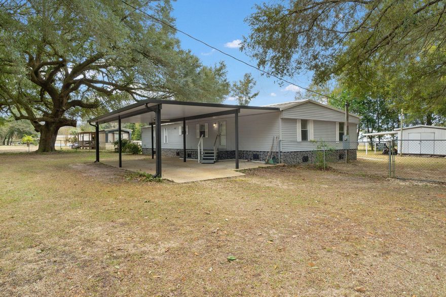 CASH ONLY property. Property does not qualify for traditional financing. Welcome to this meticulously kept 4 bedroom, 4 bathroom custom manufactured home nestled near nine mile road. This residence boasts a seamless blend of comfort and style, featuring carpet and tile throughout. The heart of the home is the custom-built kitchen, ensuring a unique and functional space. The home encompasses a large laundry room, offering convenience and ample storage. With 3 en-suites, this property provides a luxurious retreat for family and guests. Plumbing has been upgraded over the years to PVC. The spacious living area and den create an ideal setting for family gatherings or game day events, offering versatility and comfort. A distinctive feature is the custom-built aluminum carport at the front, providing a covered space for homeowners to pull under and unload vehicles without being exposed to the elements. Outdoor living is enhanced by a chain-linked fenced backyard, providing privacy and security. Additionally, a storage shed adds practicality to the property, offering space for tools and equipment. Don't miss the opportunity to make this meticulously maintained home yours - schedule your showing today!

