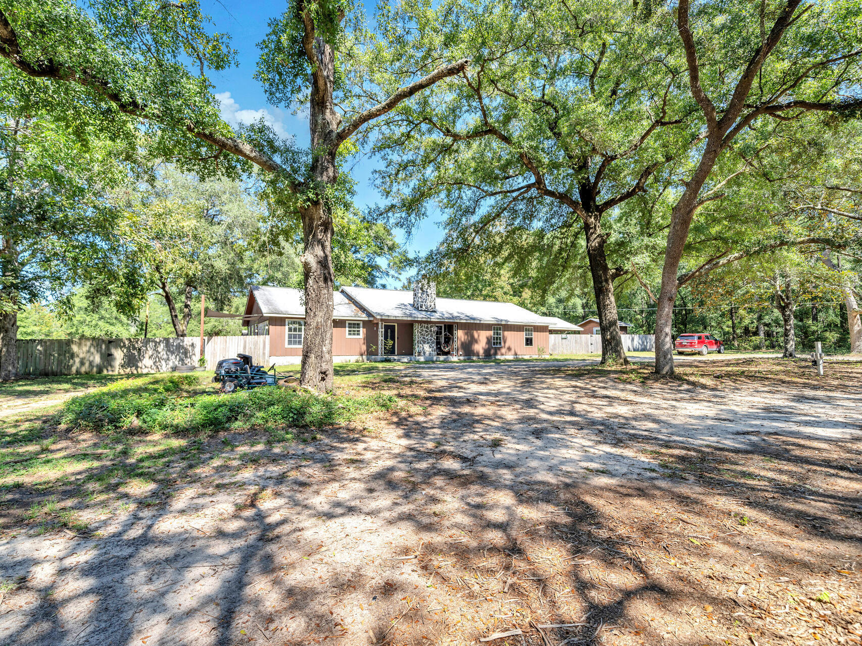 This Crestview gem resting on two acres overlooking a peaceful lake offers modern upgrades and peace of mind with key improvements already in place. Step inside to discover the spacious family room with vaulted ceilings perfect for gatherings, relaxing, or creating the ultimate entertainment space. Five bedrooms provide ample room for family and friends while two bathrooms feature tiled showers and contemporary vanities. Low maintenance wood-look porcelain tile flooring has been recently installed throughout and neutral paint colors make it easy to personalize the home to your own tastes. The modern upgrades continue with a 2022 HVAC system, a 2023 tankless water heater, and a 2017 roof, providing peace of mind for years to come. Outside, the property offers plenty of potential with a shed as is ready for your toys and a workshop that, while needing some attention, conveys as-is. Whether you're dreaming of creating a serene country oasis, need space for hobbies, or simply want to relax by the lake, this home has it all.