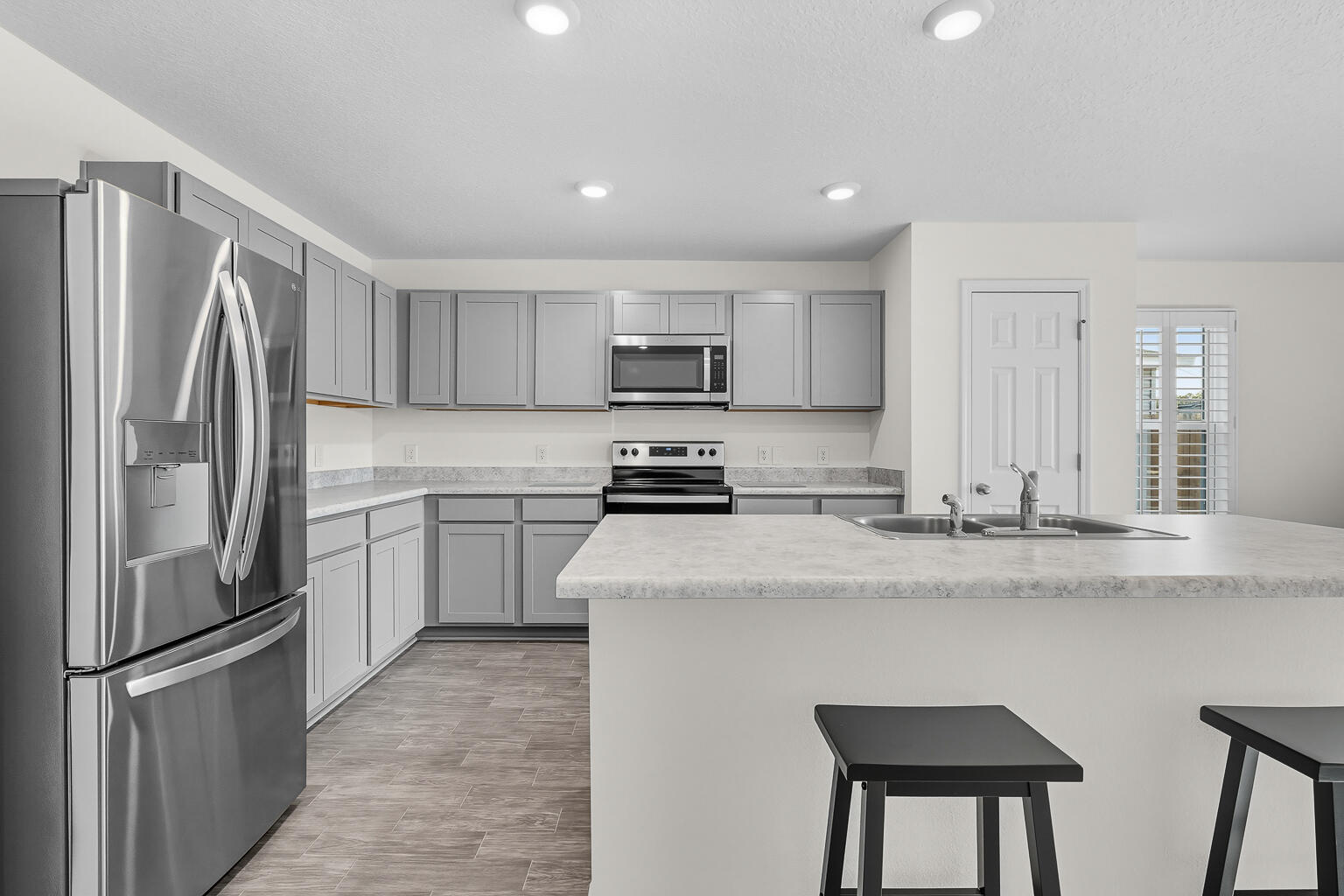 MOVE-IN READY 2024 BUILD WITH BRAND NEW FURNITURE INCLUDED! This nearly new 3 bedroom, 2 bath home in Milton, Florida delivers exceptional value with all brand new furnishings and appliances included. Never fully occupied, the property feels fresh and well maintained, offering an open concept floor plan with a spacious living area, modern kitchen with island, stainless steel appliances, and a neutral interior finish that complements any style. Features include newly installed plantation shutters for privacy, washer and dryer, and even an electric lawn mower for added convenience. Exterior highlights consist of durable vinyl siding with brick accents for low-maintenance living. An active termite warranty provides additional peace of mind. Conveniently located with quick access to Hwy 90 and I-10, this home offers modern features, complete furnishings, and transferable warranties ready for its new owner!