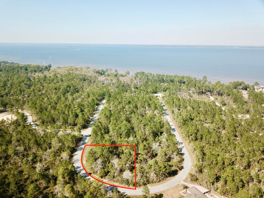 Large corner lot in the new Seclusion Bay subdivision. Short walk to the community dock on Choctawhatchee Bay. This gated community offers 53 estate size lots with 15 acres of preservation areas giving the feel of much larger and private home sites. The community is only minutes from the beaches of South Walton and the shopping and restaurants of Sandestin, Grayton Beach, Seaside and Watercolor. No build out time.