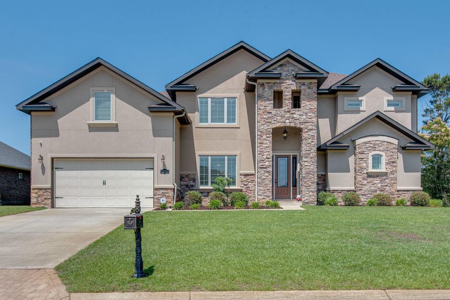 Welcome home to this outstanding dream property in East Navarre! This oversized 6 bedroom home on an elevated property and built like no other! The builder thought of the elegant design and quality in the making of this house. Not only do you have plenty of space with 6 bedrooms, but you also have your own private home theater perfect for game day and movie nights. The kitchen makes for a fantastic entertainment area for guests and family to visit and also relax in the newly added sunroom. The back yard is fully fenced for privacy and has PLENTY of room for a private pool. You will also enjoy the luxury of this gated community that is located on the Sound side. The home has upscale plantation shutters, plenty of natural light with beautiful custom finishes & so much more! MUST SEE!!