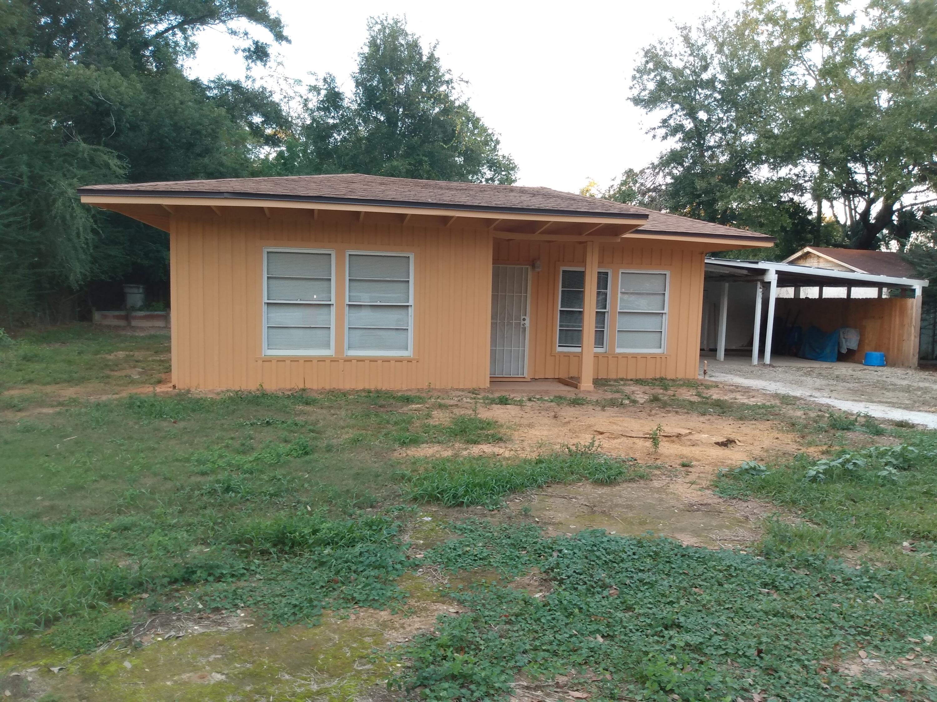 In town living. 3 miles straight north of NAS Base Pensacola. 2 bedroom 1 bath with carport tucked away off the main road on a dead end street with no thru traffic giving plenty of privacy with convenient access to Pensacola amenities and also zoned HC/LI. This zoning which is a rare find and property is nearly a 1/2 acre. House has a new roof, interior doors, 36''exterior back door with stoop making it wheelchair accessible, cabinets, drywall work, paint, yard leveling/elevation work, interior/exterior sewage lines with underground electric utilities, new exterior paint and recently remodeled primary bedroom with new mini split unit. All appliances, washer, dryer and two mounted window units and mini split stay. Primary bedroom is oversized and both bedrooms have good closet space. Furniture if negotiable. Move right in or rent it furnished. Solid home with good bones. Would make a great starter home or vacation house close to the beaches. Price is firm in this up and coming area. Location, Location, Location. Move in or start a business with this zoned lot in a quaint cottage home. It's 30 minutes to Pensacola and/or Perdido Beach. Within a short walking distance of dining, shopping, and much more. VA clinic/hospital and PX just a 5 minute drive away as well. You could flourish here without a vehicle.