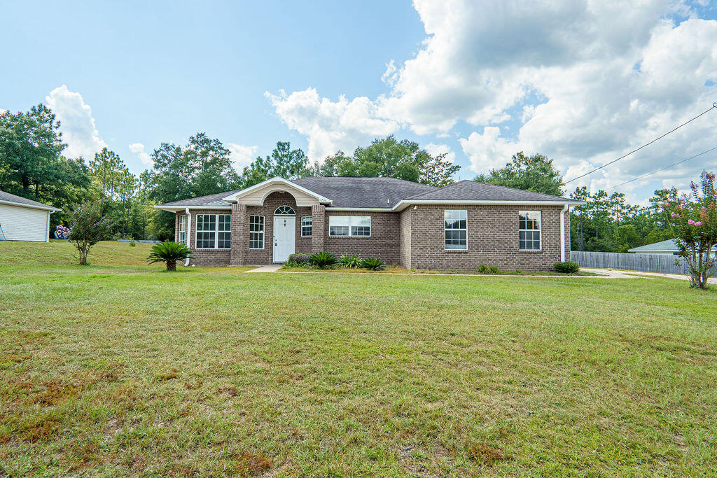 Charming Crestview Home for Sale! Built in 2007, this spacious single-family residence is a perfect blend of comfort and style. The home features 3 bedrooms, 2 bathrooms, and a 2-car garage. Inside, you'll find an open floor plan with tile flooring throughout the main living areas and carpeting in the bedrooms. The living room has cathedral ceiling and plant shelves, creating an airy and oversized feel. The kitchen is large as well and has that open and airy feeling including a space for a breakfast nook. Kitchen island is convenient and is perfect for meal prep and entertaining. Conveniently located, this neighborhood is less than 4 miles from Crestview High School and a must see. Call today!