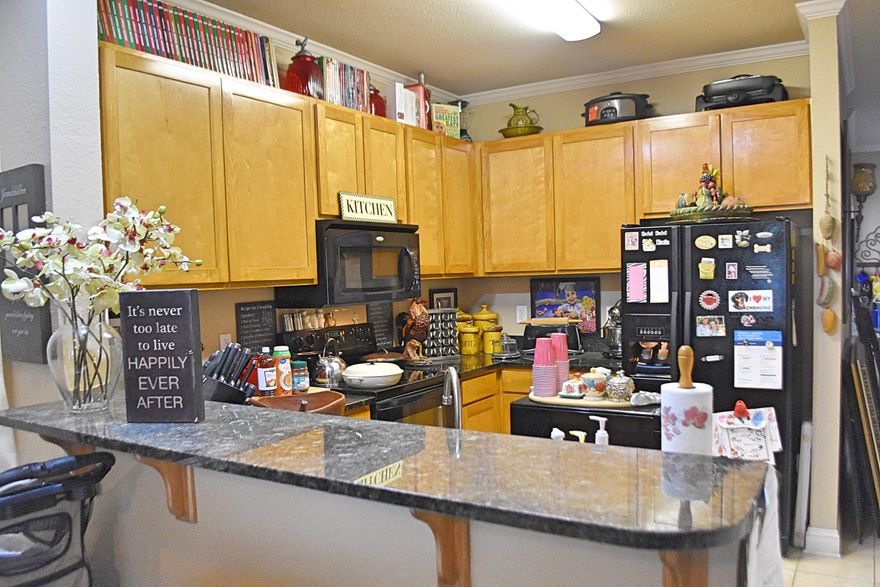 Classic sophistication and design merge in this end unit with tile in kitchen, foyer and all bathrooms, 9' ceilings on the first floor and stylish berber carpet in living room and bedrooms. Kitchen adorned with black Whirlpool appliances, Fridge with water and ice in the door, Uba Tuba granite counters and breakfast bar. Plenty of storage to include pull down stairs to attic, pantry, coat/broom closet and laundry room with wire shelves for extra items. Half bath with pedestal sink just around the corner from the office with double french doors. All bedrooms located upstairs with ceiling fans and two bathrooms with tub/shower combinations-the master vanity has granite counter-tops. Spacious covered patio for your relaxation overlooking the green space, natural landscape and walking distance