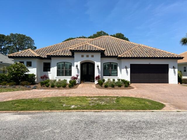 Custom Home on the 17th fairway of Emerald Bay. Relax on the lanai with outdoor fireplace, summer kitchen, heated pool and spa. Large open kitchen and living room are designed with entertaining in mind!  Home also boasts 10' ceilings and hurricane rated impact windows along with 8' interior and exterior doors. Wonderful kitchen with twin islands, double oven and built in ice maker.  Views of the bay from the backyard.  The home has 3 bedrooms, with a flex room in the front of the house, which is currently an office, could be transformed to a 4th bedroom or playroom.  Don't miss this one, it's sure to go fast!