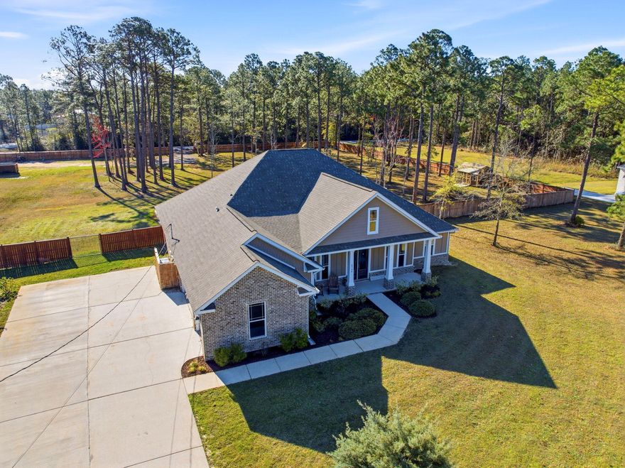 Welcome to a truly rare, one-of-a-kind 3+ ACRE DREAM HOME in Navarre--where privacy, space, and convenience come together. Acreage of this size is typically found far outside town, yet here you are just 15 minutes from the beach, enjoying the best of both worlds. An exceptional opportunity like this is rarely available, especially within a community offering a low HOA of just $595 per year.This custom, one-owner home offers over 3,300 square feet of heated and cooled living space, complete with an inground pool and paid-in-full solar panels, providing long-term energy efficiency and savings. A brand-new, oversized HVAC system was installed in July 2025, thoughtfully selected for enhanced comfort and efficiency throughout the home. Natural light pours into the expansive entryway, welcoming you into a thoughtfully designed layout featuring four spacious bedrooms with privacy on each end of the home, plus two additional offices--currently used as a den and a children's playroom--offering endless flexibility for work, play, or multi-generational living.

The property is fully fenced with massive front and rear metal gates, making it ideal for storing an RV, boat, or other recreational toys. Vaulted ceilings accent the living room, primary suite, office, and formal dining area, adding volume and elegance throughout. The home was custom built in 2018 and has been meticulously maintained.

Residents enjoy access to a resort-style, multi-million-dollar recreational center featuring multiple pools, tennis courts, pickleball, a fitness center, sauna, steam room, and boat launch access--an incredible amenity at an unbeatable value.

Additional highlights include a large laundry room with a built-in mudroom bench and storage, programmable Wi-Fi thermostat, security system (conveying), stained modern fencing, 13-zone irrigation system, triple-car garage, extended driveway with ample parking, pull-down attic stairs, electric rear gate, and hurricane fabric shields stored for all windows and doors, offering excellent insurance benefits.

The chef's kitchen features rich, dark soft-close cabinetry, two pantries, under-cabinet lighting, gas cooking, and an open flow to the main living area--perfect for entertaining and everyday living.

Most importantly, this is over 3 acres of fully usable land--a rare find in Navarre, where many properties of this size include wetlands or non-usable space.

Located just up the road from the Holley by the Sea boat ramp, this property truly has it all.

Join us for a double open house weekend:

Saturday 21st  | 11:00 AM - 2:00 PM

Live musician, complimentary food and drinks--come experience everything this extraordinary home has to offer.

Welcome to your 3-acre dream home.