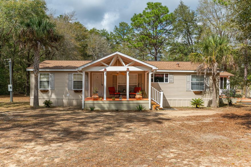 ***Multiple Offers.  Highest and best due by 5pm Monday 3/21*** !Looking for a quiet serene location? This home is the one for you.  Well maintained 3 bedroom 2 bath home with a large kitchen and a wonderful sunroom.  Enjoy your mornings and evenings on the large covered front porch or side decks.  Are you interested in going green?  This home has solar panels and a new roof.  Don't let the dirt road scare you off....it's only .2 miles off the paved road.  Microwave and shed convey as is.