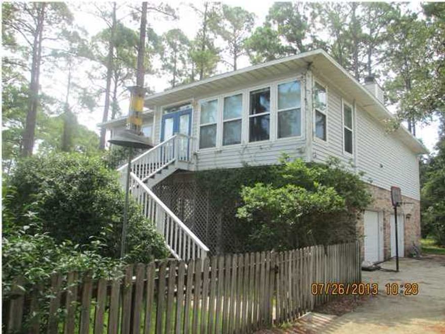Short Sale - pre-approved price! Bay views from this large two story home situated in the peaceful and friendly of Santa Rosa Beach Estates. There are two bay accesses in the community for launching boats; one of which is public and the other for homeowners only. This open and airy home has wonderful areas in which to entertain guests, family and friends. The two bedrooms, full bath and retreat area located on the first floor resembles a lovely bed and breakfast which offers a peaceful and private get-a-way when the day ends. The street is quiet, secluded. Beautiful yard with easy boat launching, shopping and the beach is only minutes away. The large landscaped lot is primarily planted with native fauna and perennials so yard is easily maintained
