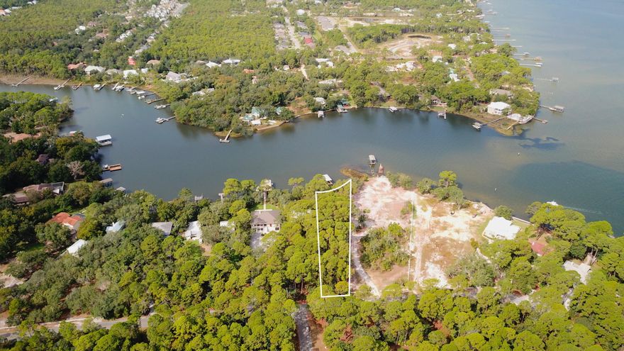 This deep water bayou front lot in Santa Rosa Beach offers approximately 100 feet of prime water frontage along Hewett Bayou. Covering just over three quarters of an acre it offers direct access to Choctawhatchee Bay and the Gulf of Mexico beyond. The lot offers a newly built dock with boathouse and boat lift.