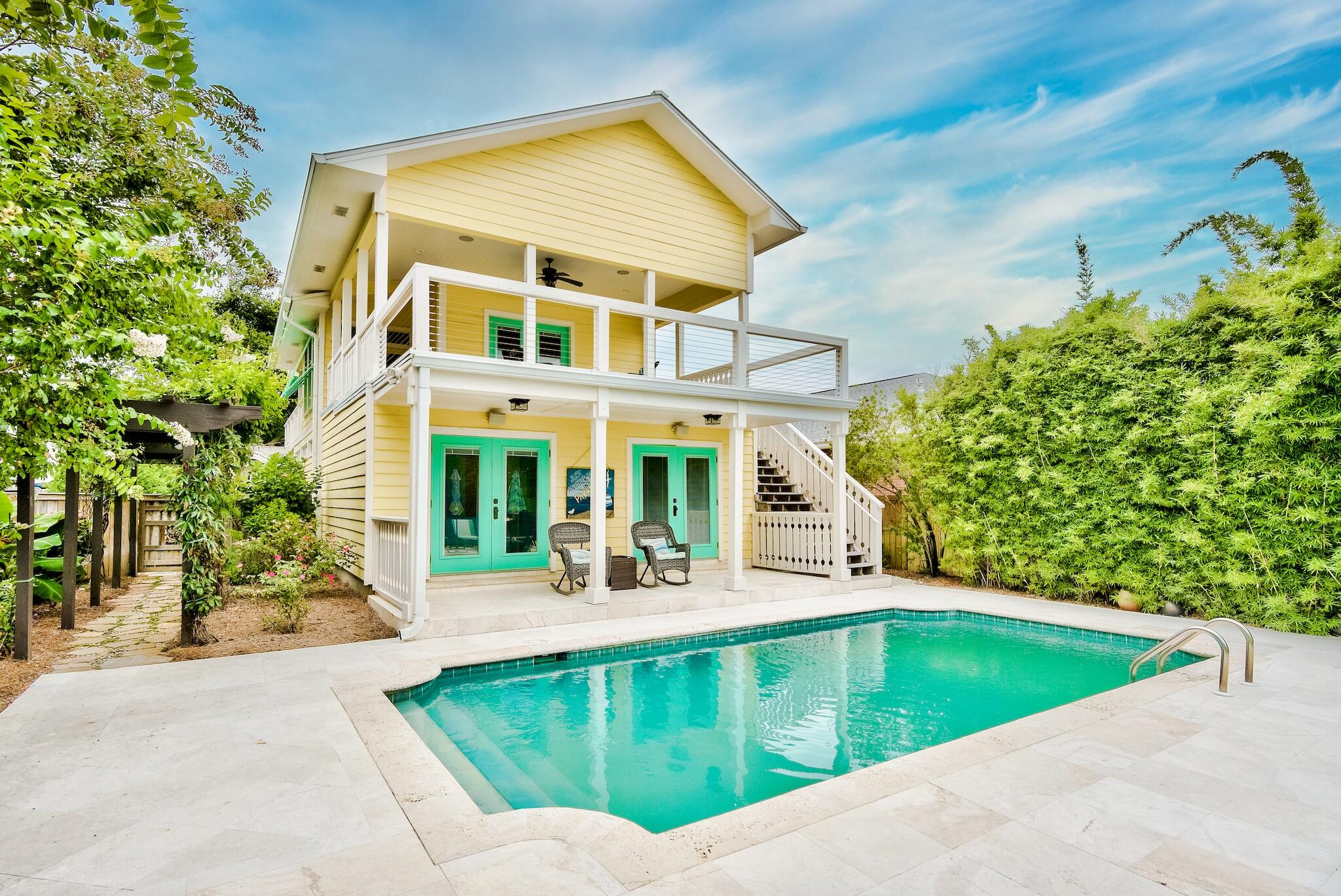 Half a block from the sugar white sands and emerald waters of Crystal Beach, this elegant coastal five bedroom, three and a half bath residence is tastefully updated, landscaped, and poised to become a new primary or secondary home, or exceptional vacation rental. Desirable features include the extra-deep lot with a one car garage, private pool, outdoor bar pagoda, lush side courtyard with a soothing fountain, Italian limestone, and high-end finishes, setting this home apart from anything comparable. Hand-milled walnut flooring accentuates the fabulous open living area and commercial-grade luxury kitchen with durable granite countertops, two Sub-Zero refrigerators, large Wolf gas range and a wine fridge. Enjoy drinks on the expansive breezy second story deck off of the living area.