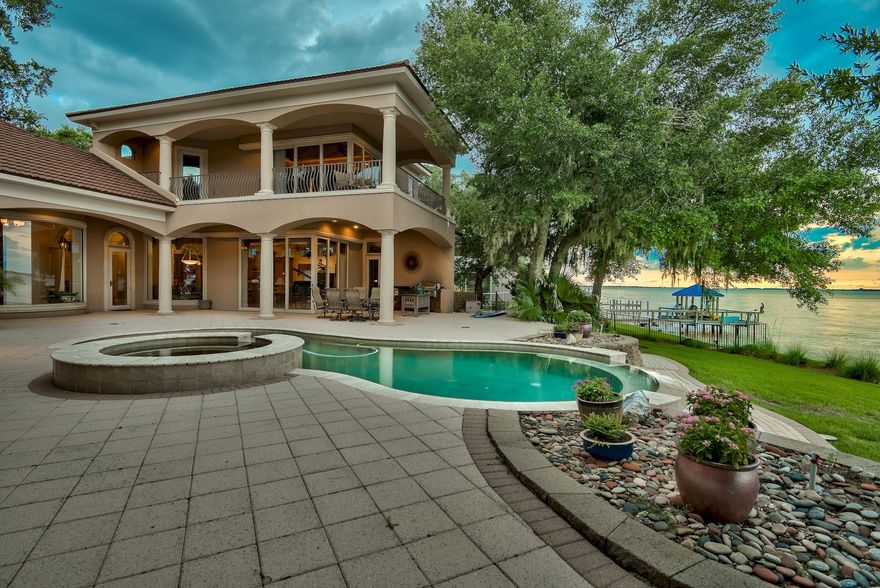 Stunning, ICF-constructed Mediterranean retreat on a massive 725-ft stretch of waterfront offers unmatched privacy and stately proportion. A long winding driveway, lined with shadowy live oaks, leads the way to a majestic 1.5-acre expanse located at the meeting point where the Choctawhatchee Bay joins Marler Bayou, offering prime water frontage and unique seascapes from two sides. This showpiece's timeless, luxurious interior appointments and opulent outdoor scaping are matched in exquisiteness only by the surrounding natural scenery. A spectacular, visually stirring bayfront oasis features an elevated deck with freeform infinity-edge pool and spa, covered seating, and well-appointed summer kitchen. Each dock - a swimming dock and a protected boat dock  offers deep-water access.