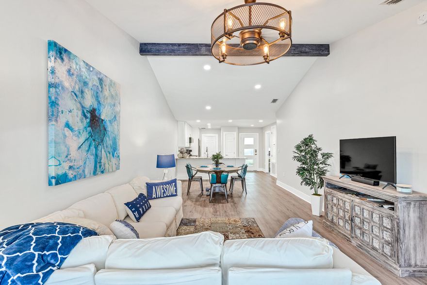 NEWLY RENOVATED!  JUST A QUICK BIKE RIDE TO THE BEACHES ON 30A!  This like-new 3BR/2BA townhome is perfectly suited as a full-time residence or second home.  No detail has been overlooked in this single level home with standout finishes including vaulted ceilings, wide plank LVP flooring, custom cabinetry and designer lighting.  The welcoming and spacious living area opens to a patio and deck overlooking the private fenced-in backyard while the fully equipped kitchen offers stainless appliances, soft-close cabinetry, tiled back-splash and granite counter tops.  Off the kitchen is a butler's pantry/laundry area which is complete with a wine refrigerator and additional counter and cabinet space.  Other highlights include garage, backlit vanity mirrors, tiled showers and stylish plumbing