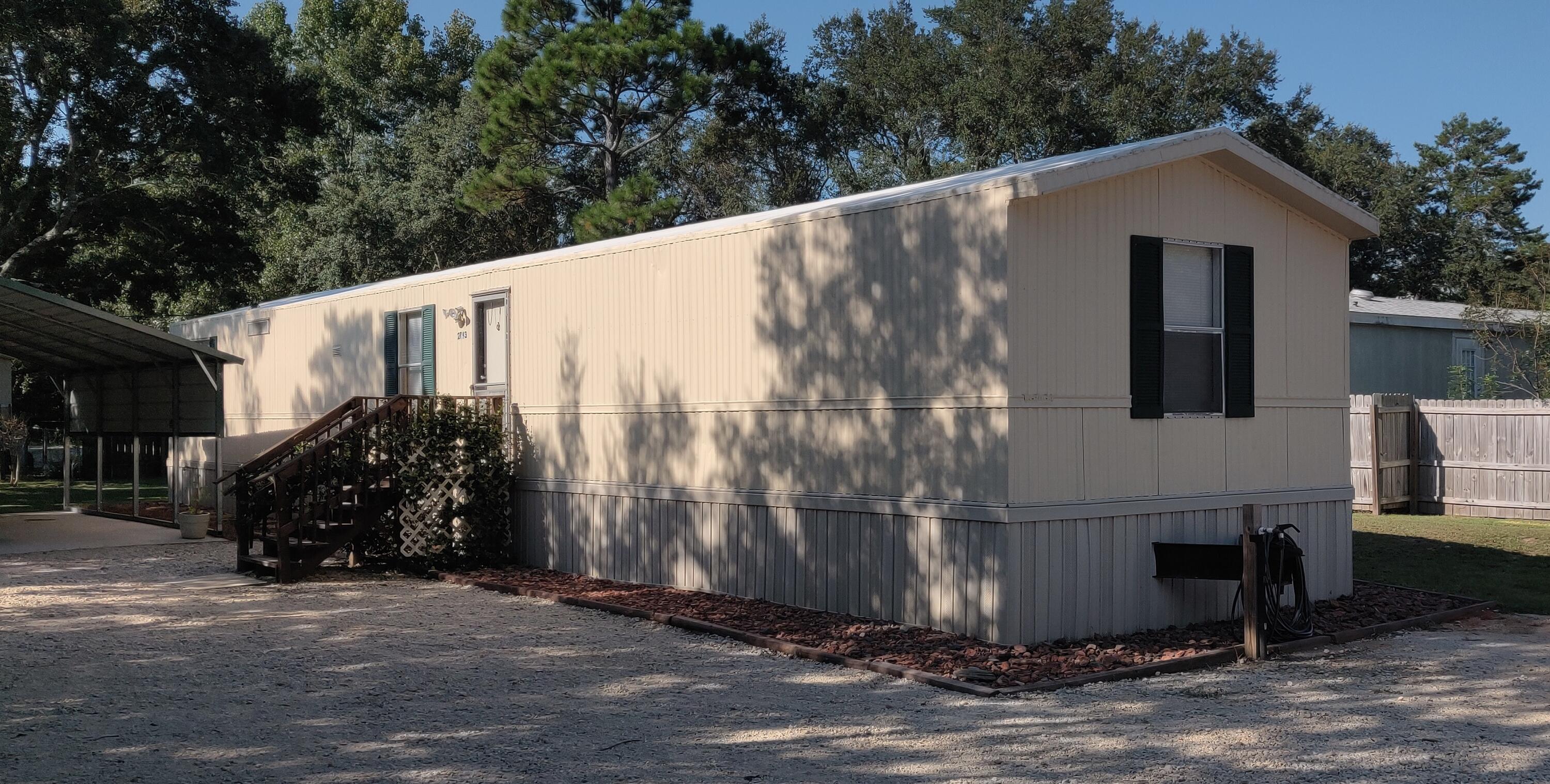 Investment opportunity or a great primary residence for a cash buyer. This half acre property features a 600 SF detached workshop with 10' roll-up door and 100A service panel. The shop is outfitted with a 60 Gal compressor with hose reel, LED overhead lighting, and two 220v outlets. The 20' wide metal carport has a concrete pad, and there is also a 80 SF metal shed for the yard equipment and outdoor toys. The road frontage is privacy fenced with two large gates, connected with a gravel circular drive.The 924 SF single-wide mobile home has 3 bedrooms and 2 full baths. The septic system, power pole and water lines were installed when the home was moved to the parcel in 2016.