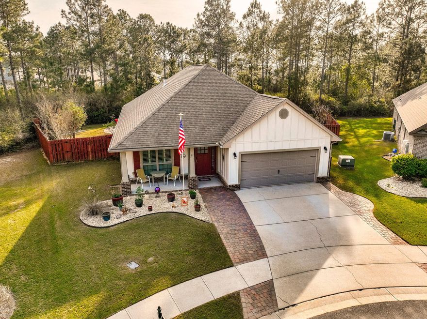 All brick immaculate 3 bedroom, 2 bath home, located on a quiet cul-de-sac and backing up to a nature preserve for privacy and peace and quiet.  This home has many upgrades, a private office area or bonus room with french doors, open floor plan, oversized kitchen island, stainless appliances, tear drop lights over the island and extra kitchen storage all with granite counter tops.  All tile throughout the entire home, all bedrooms have walk-in closets with wood shelving.  Laundry room has upgrades of gas plumbing for a gas dryer, storage cabinets and hanging rack.  Primary bedroom ensuite has a fully tiled shower, double sinks, granite counter tops, extra storage space and wooden closet organization system.  Enjoy the gas fireplace in the main living area that opens up to the the enclosed