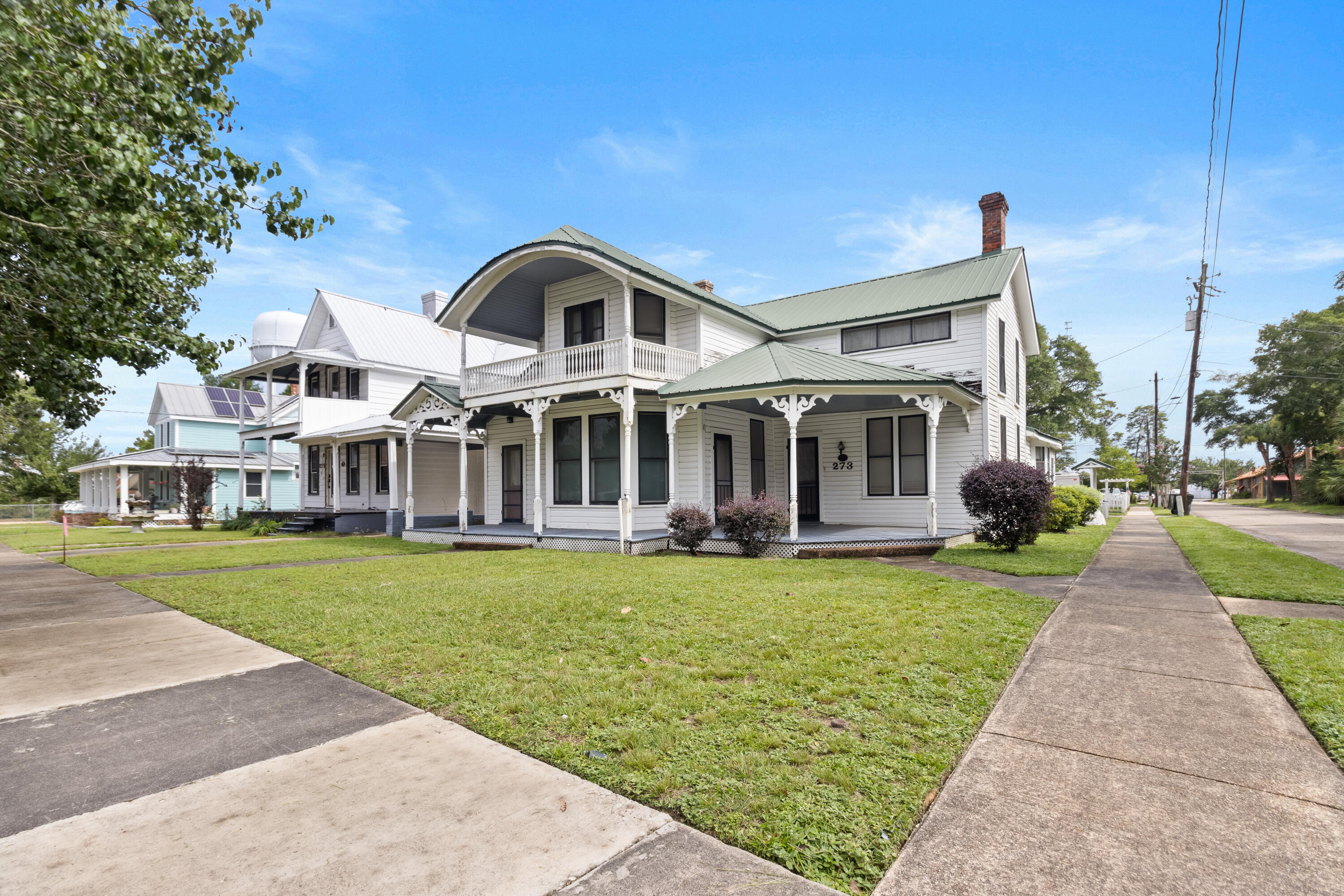 Don't miss the chance to own a piece of history with this stunning 1895-1900 Queen Anne-style Victorian home! Located in the Historic District of DeFuniak Springs, this property is just half a block from the oldest library in the state of Florida and the picturesque Lake. With over 3,000 square feet of living space and beautiful covered porches, this home truly allows you to step back in time. As you enter, you'll find spacious rooms adorned with exquisite detailing, a fireplace, and built-in bookcases in the library. The home has been thoughtfully renovated and updated with modern conveniences while preserving its historic charm. The kitchen features ceramic tile flooring, and granite countertops. The master bath includes a luxurious jacuzzi tub complemented by beautiful tile flooring. Adjacent to the kitchen is a family room/home office that invites ample natural light into the space. The combination mudroom/utility room includes a separate shower for added convenience.
This property boasts two separate staircases, a sprinkler system, and two antique outdoor streetlamps that will remain with the home. The home doesn't have central heat/air. Portable AC units are being used to cool the home.
Additionally, there is a spacious detached carport (24x32) with an attached workshop (12x24). This home was featured in Victorian Homes Magazine, and its photo has been widely used to showcase the Historic District of DeFuniak Springs.
Don't miss the opportunity to make this true piece of history yours today! All dimensions and square footage are deemed reliable but should be confirmed by the buyer at their expense. Please note that the property is located in the Historic District and is subject to the Historic Ordinance. A metal roof was installed in 2011, and the wiring and plumbing, including the shop, were completely updated in 1987 with heavy-duty 200-amp service.